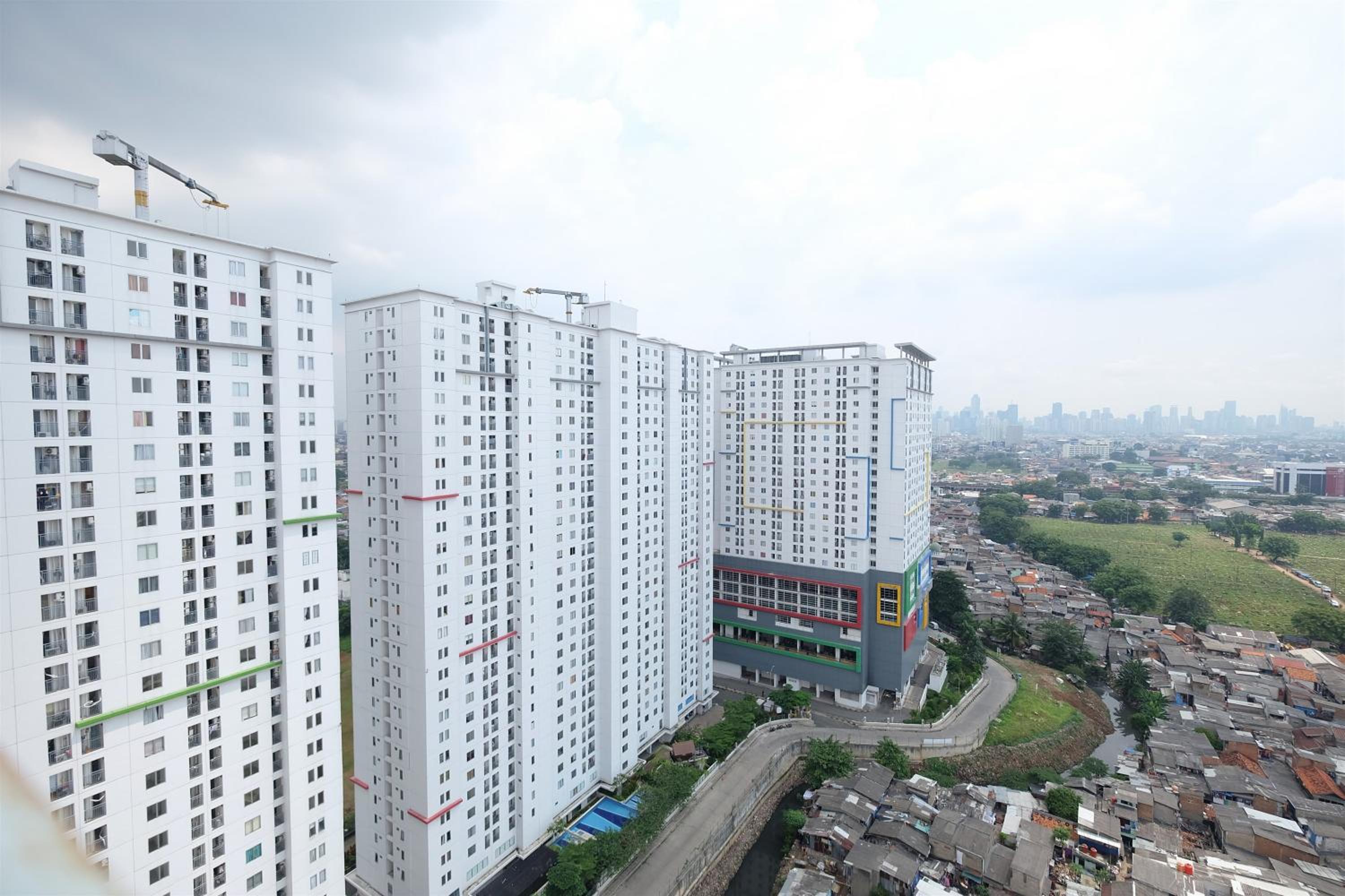 Modern Minimalist 2 BR Bassura City Apartment By Travelio