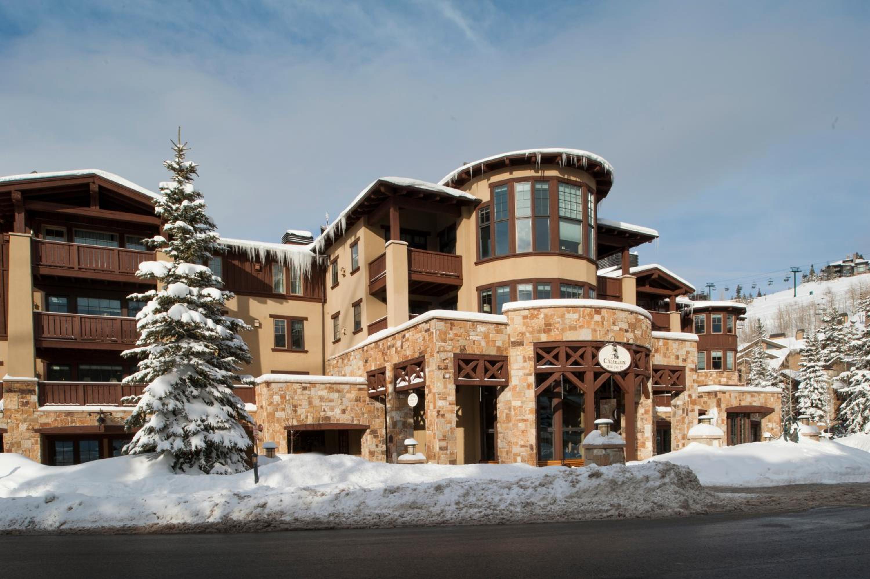 Exterior of the Chateaux Deer Valley with snow covered landscapes.