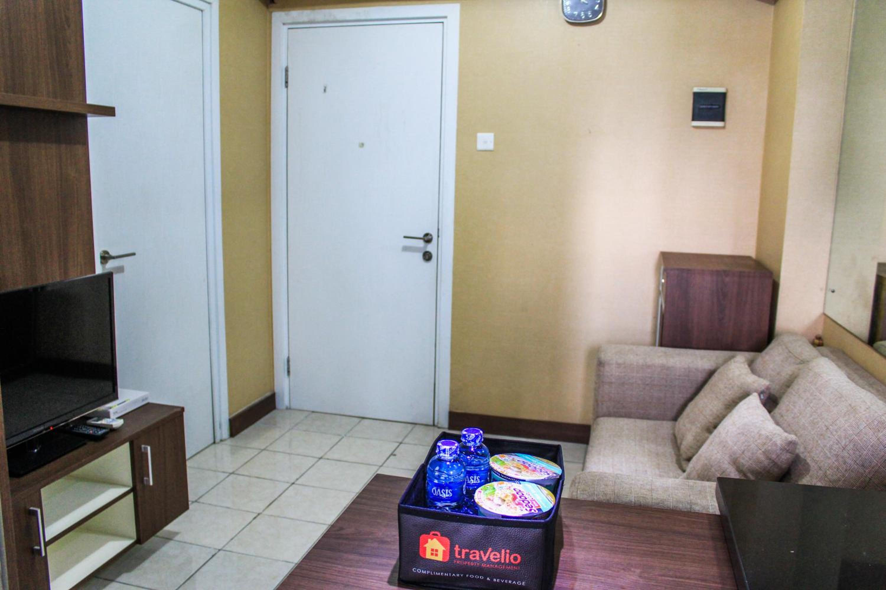 Comfortable and Tranquil 2BR Apartment at Green Pramuka By Travelio view 4