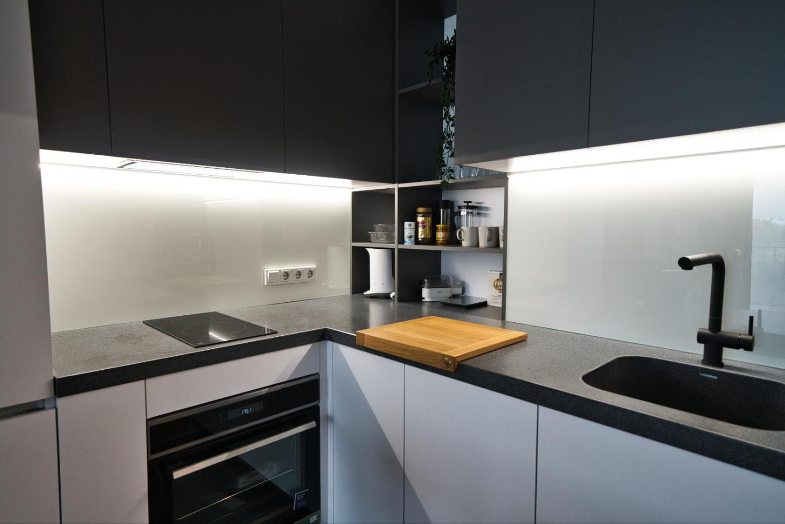Modern central Riga apartment with balcony, gym access, dedicated parking, kitchen & AC view 5