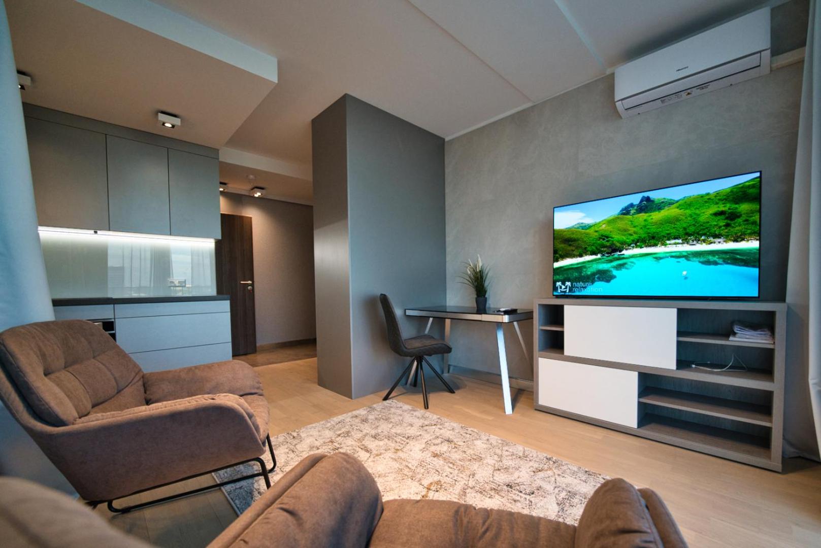 Modern central Riga apartment with balcony, gym access, dedicated parking, kitchen & AC view 4