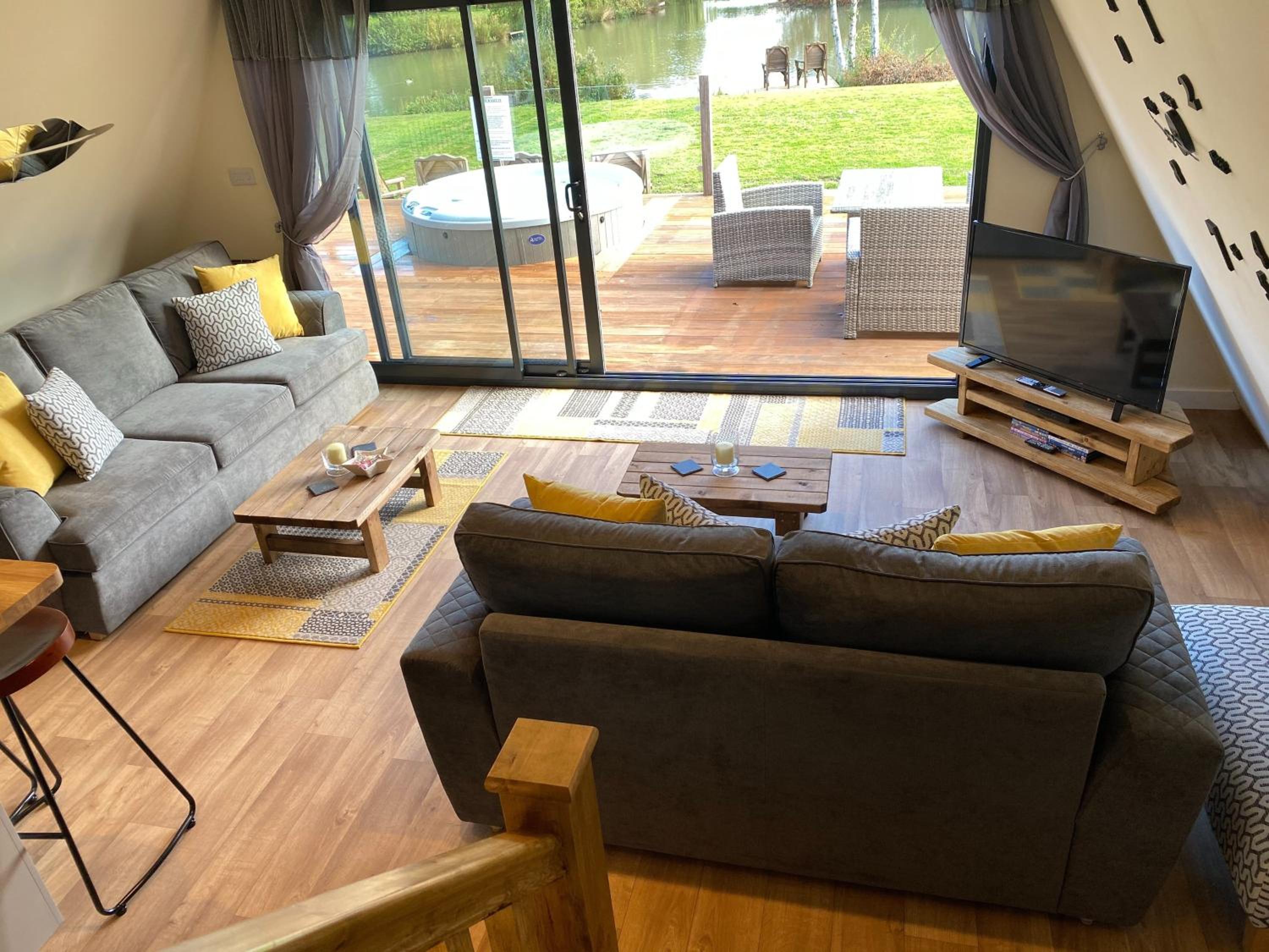 Widgeon Bespoke Cabin is lakeside with Private fishing peg, hot tub situated at Tattershall Lakes Country Park view 4