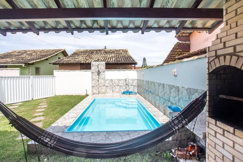 Casa com piscina, wifi e churrasqueira em unamar.