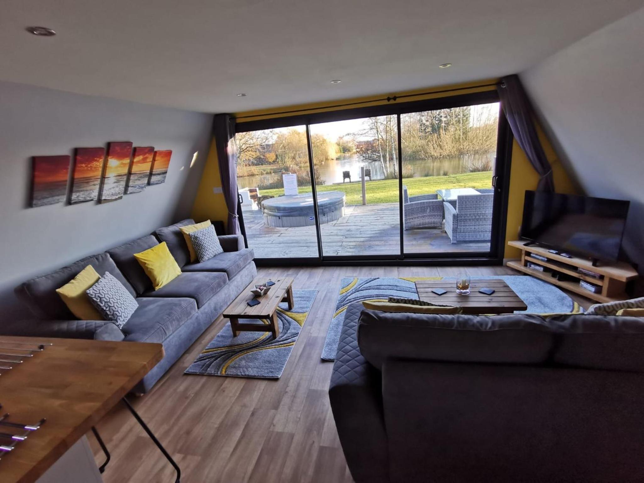 Widgeon Bespoke Cabin is lakeside with Private fishing peg, hot tub situated at Tattershall Lakes Country Park view 5