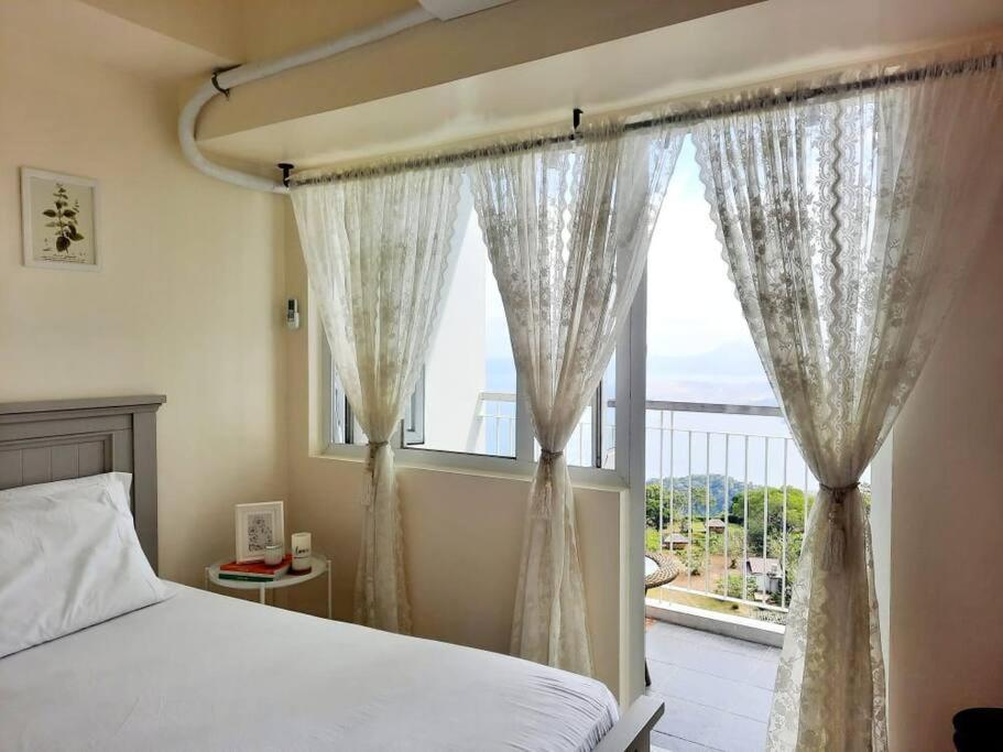 1 BR Cozy Farmhouse-Style Condo with Balcony & Taal View at Wind Residences view 3