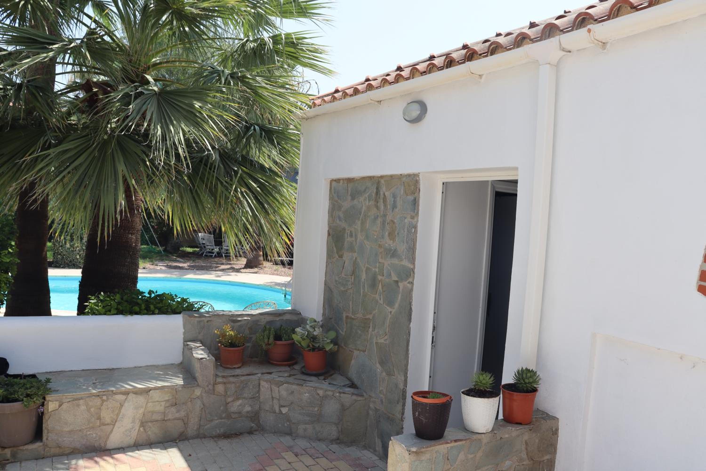 Mediterranean poolside garden cottage