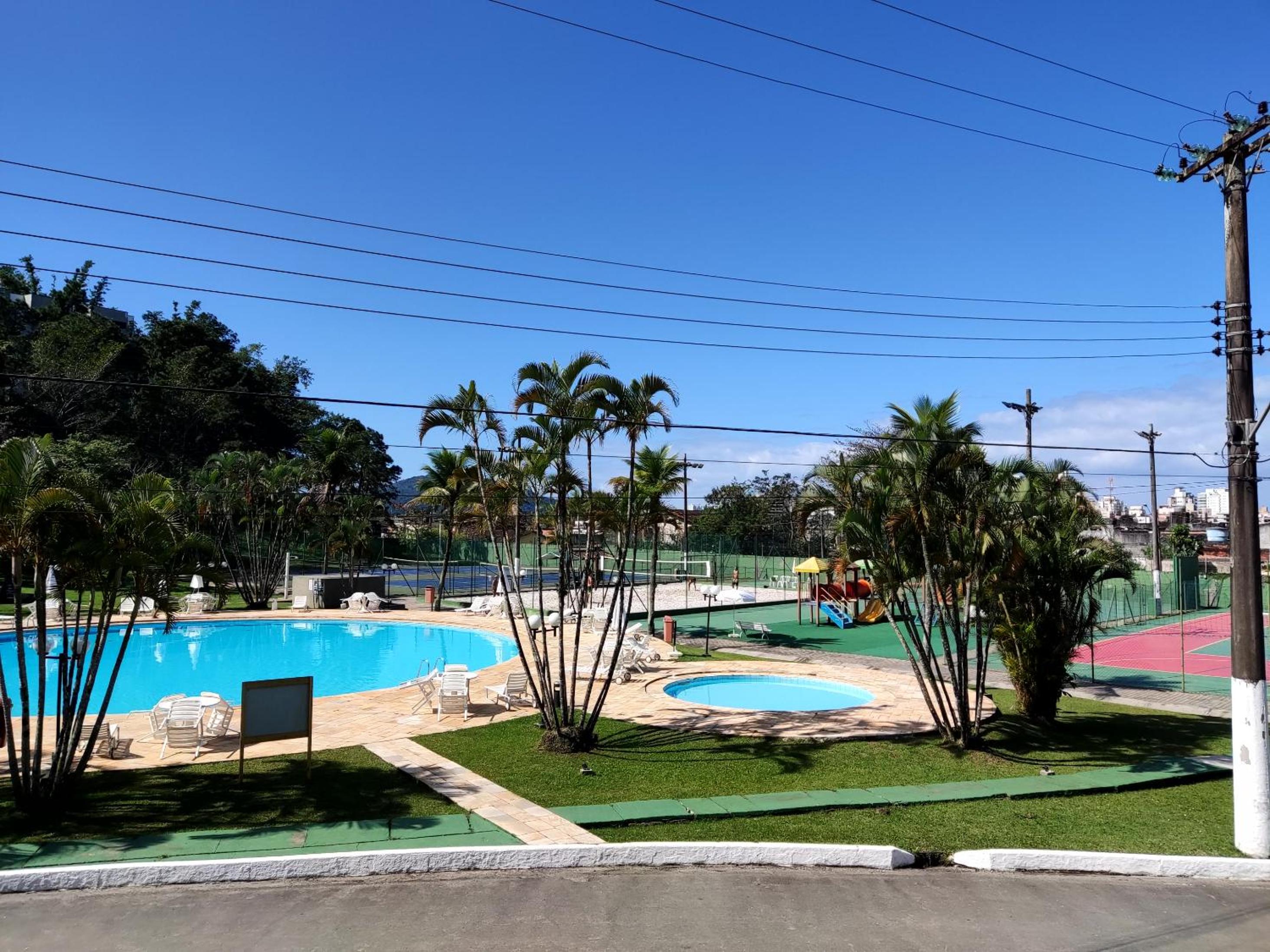 Apartamento até 10 pessoas na enseada Guarujá em condomínio clube praia piscinas salão jogos quadra futebol campo parquinho brinquedos Wi-fi Home office