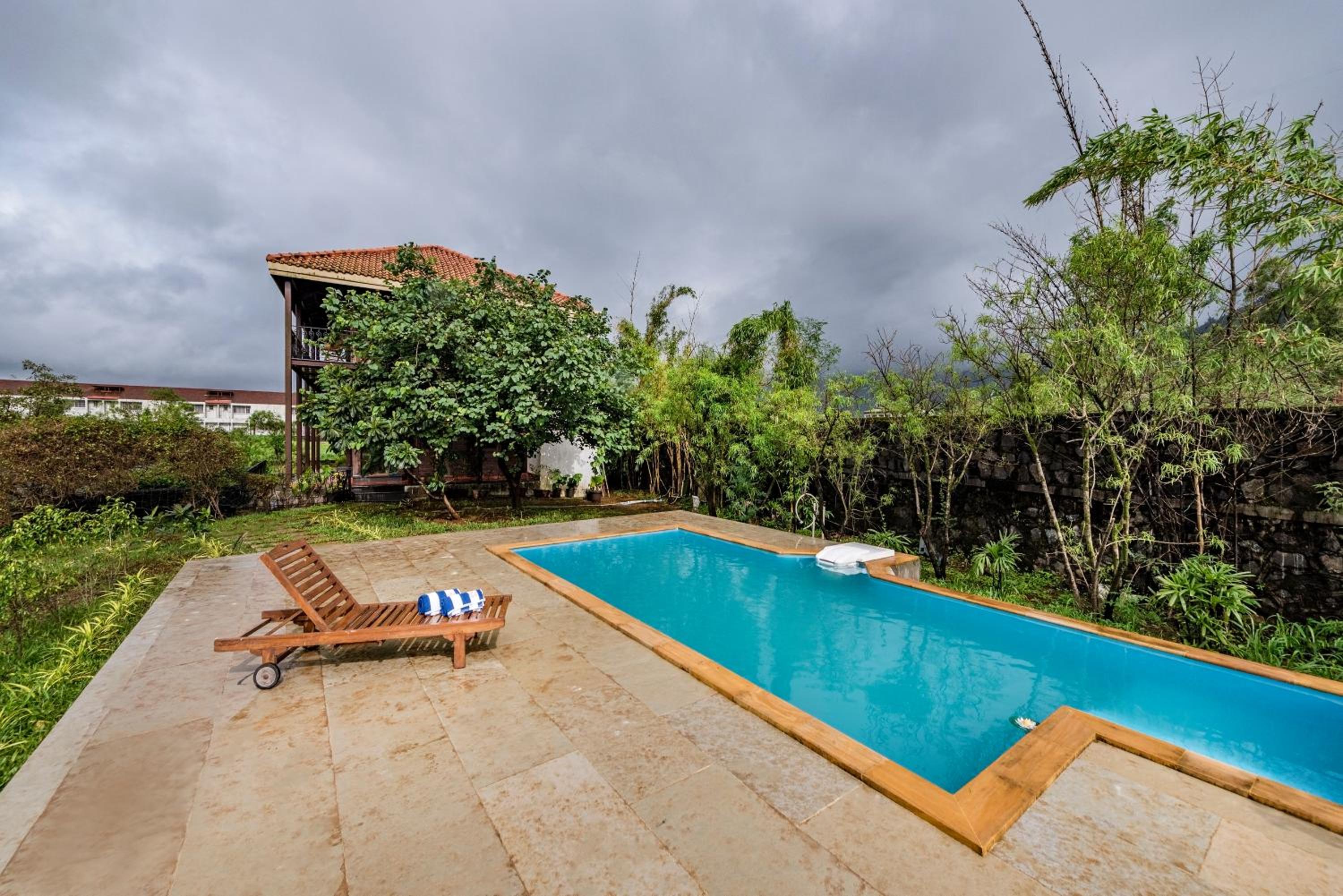 SaffronStays Boulevard LogHouse - a wooden chalet amidst nature view 2