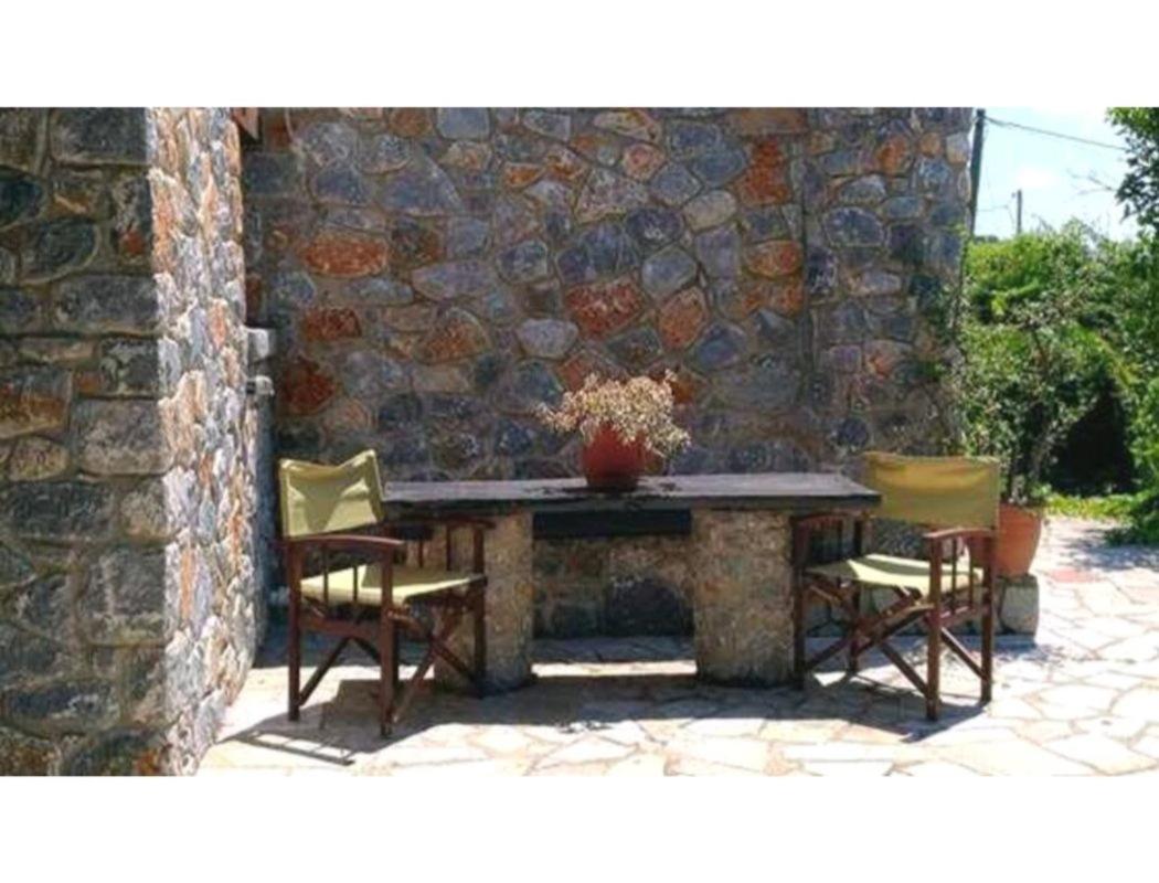 Stone house among trees view 3