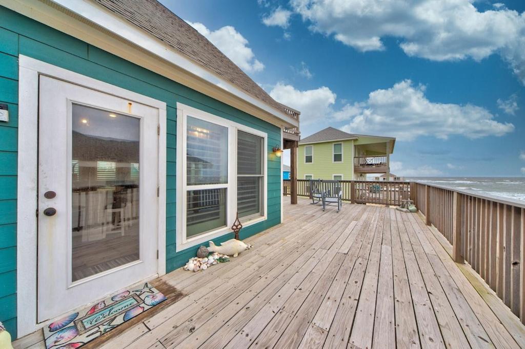 Martinis & Bikinis, a beach front house with toes in the sand drink in the hand. view 4