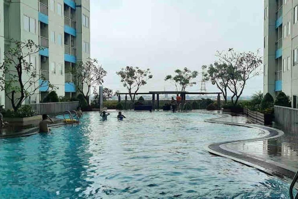 Minimalist room at The Nest Apartment by Popobella Near Puri Indah West Jakarta
