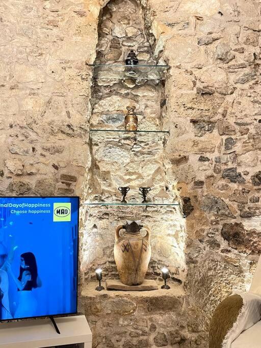 LIVING IN A CAVE UNDER ACROPOLIS