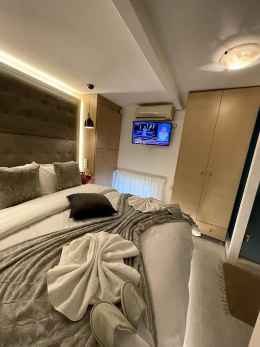 LIVING IN A CAVE UNDER ACROPOLIS