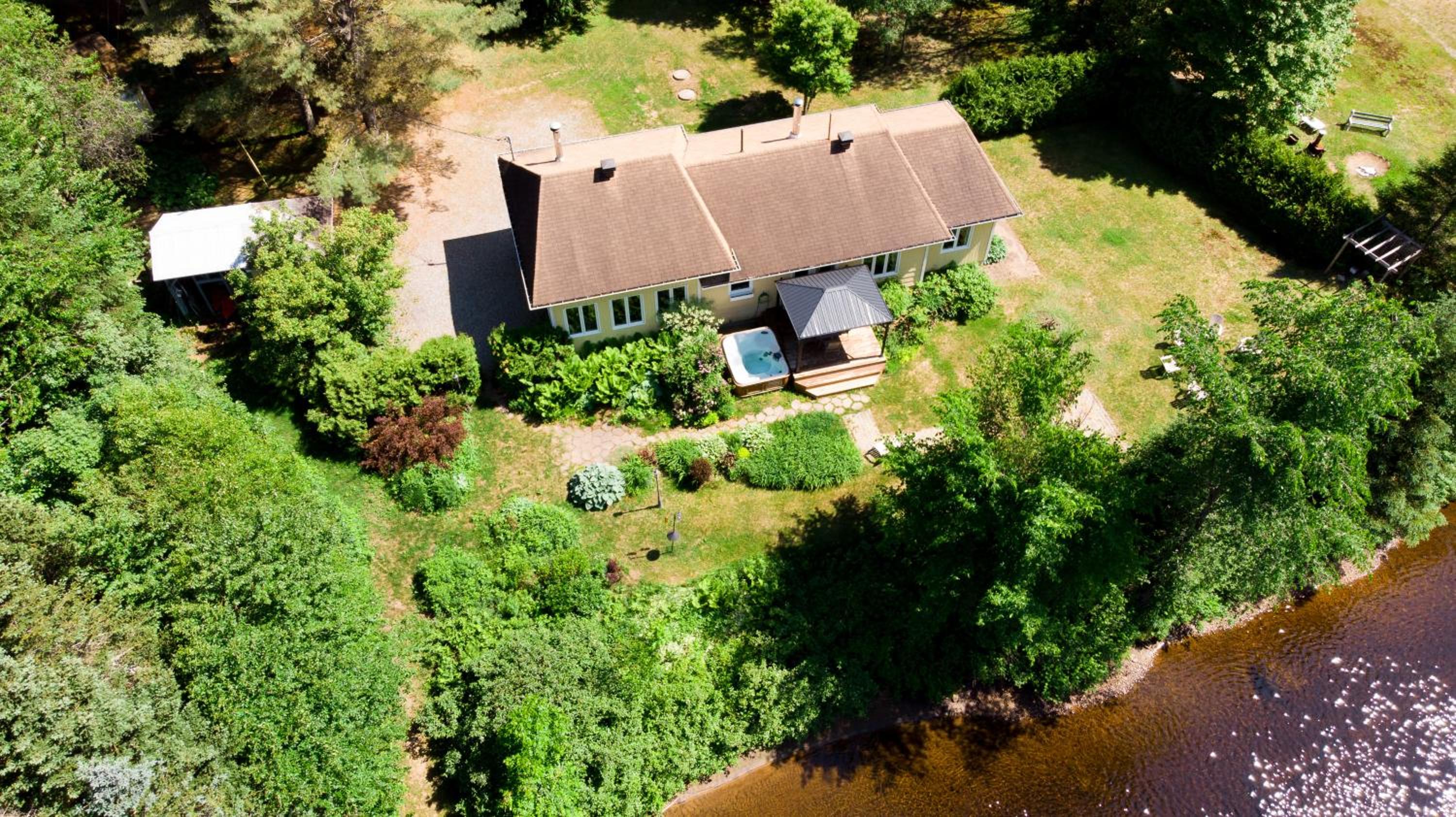 Tranquil Riverfront Chalet with Hot Tub