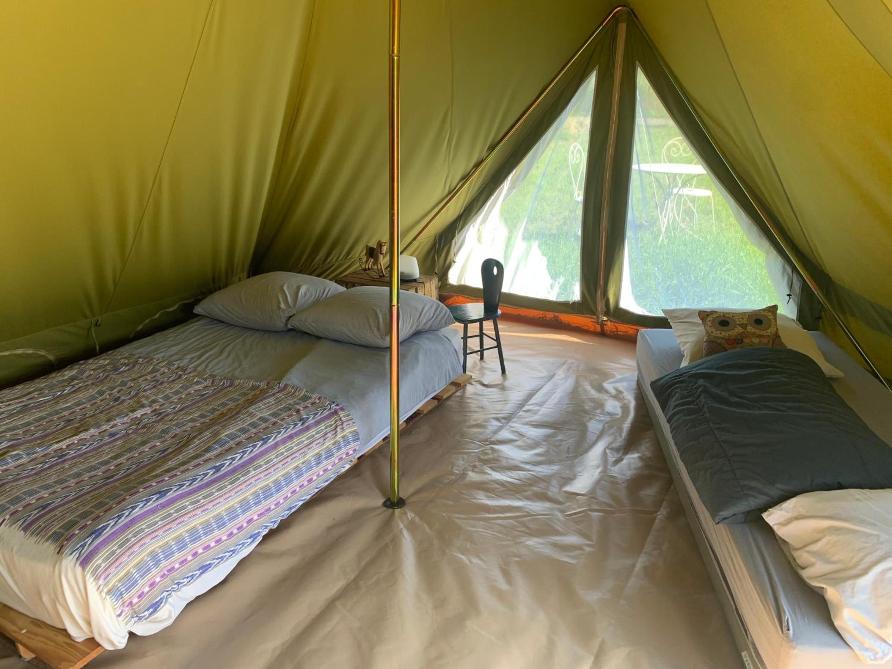 Campingspots to put on your own tent with or without electricity, with no bed for 12 euro or 25 euro and 2 furnished glampingtents for minimum 75 euro in a