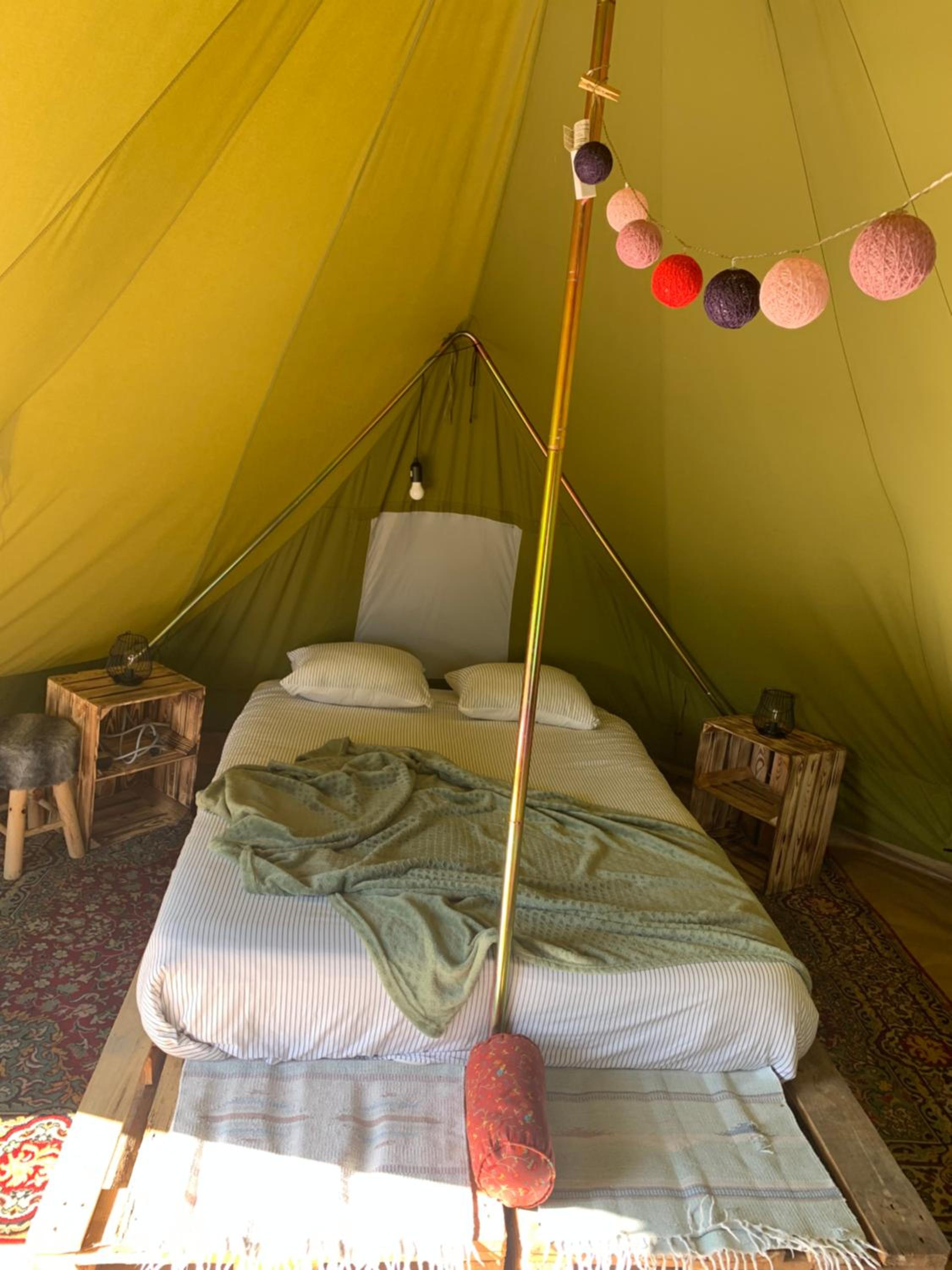 Campingspots to put on your own tent with or without electricity, with no bed for 12 euro or 25 euro and 2 furnished glampingtents for minimum 75 euro in a