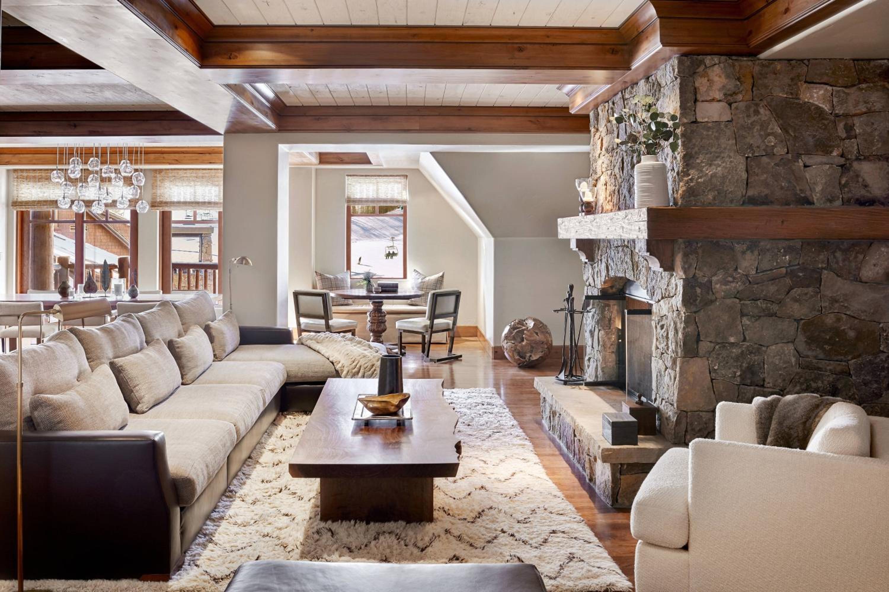 Interior of Ritz Carlton Bachelor Gulch with luxury furniture, fireplace, and clean mountain chique