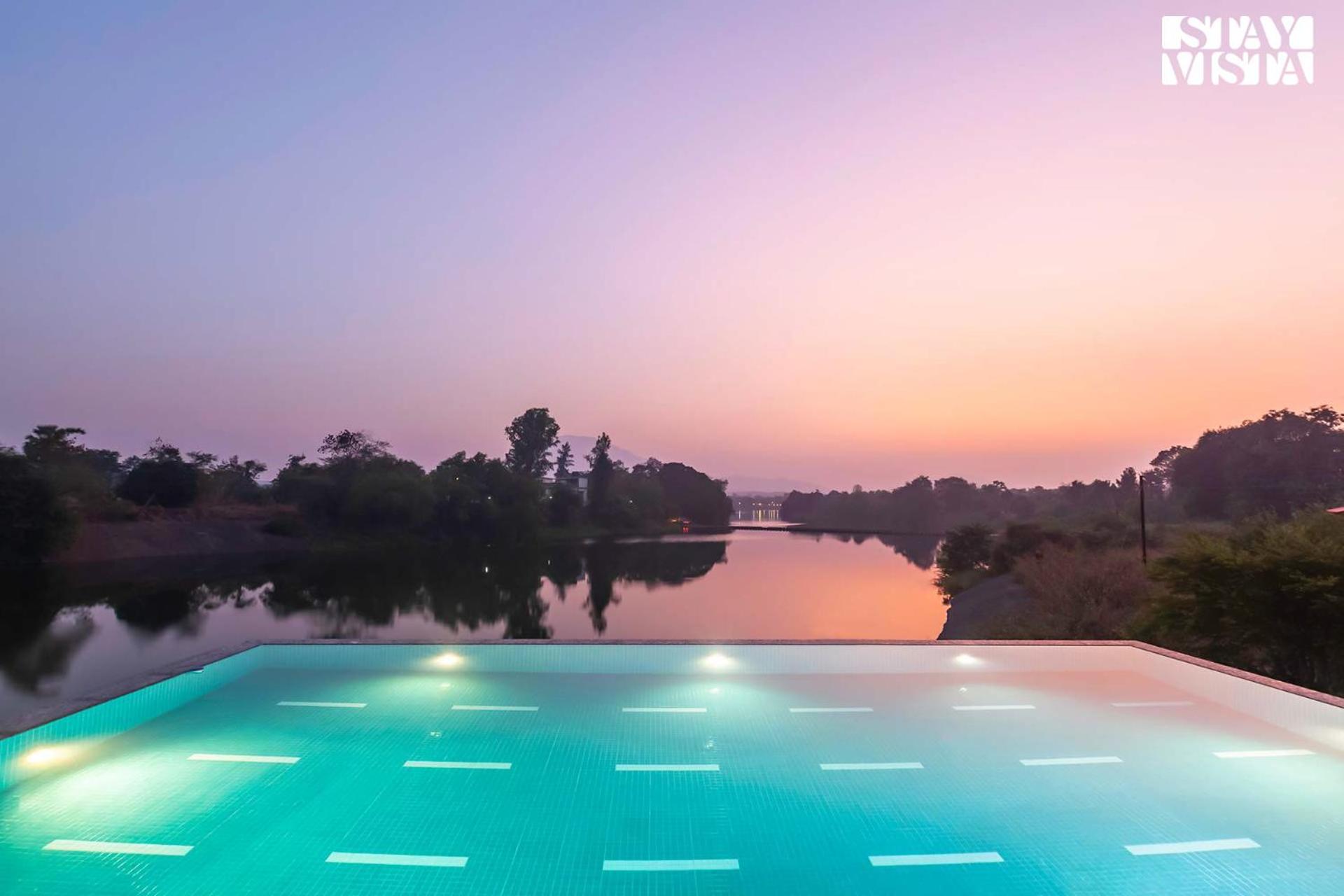 StayVista's Waterway Retreat - Lakeside Oasis with Infinity Pool