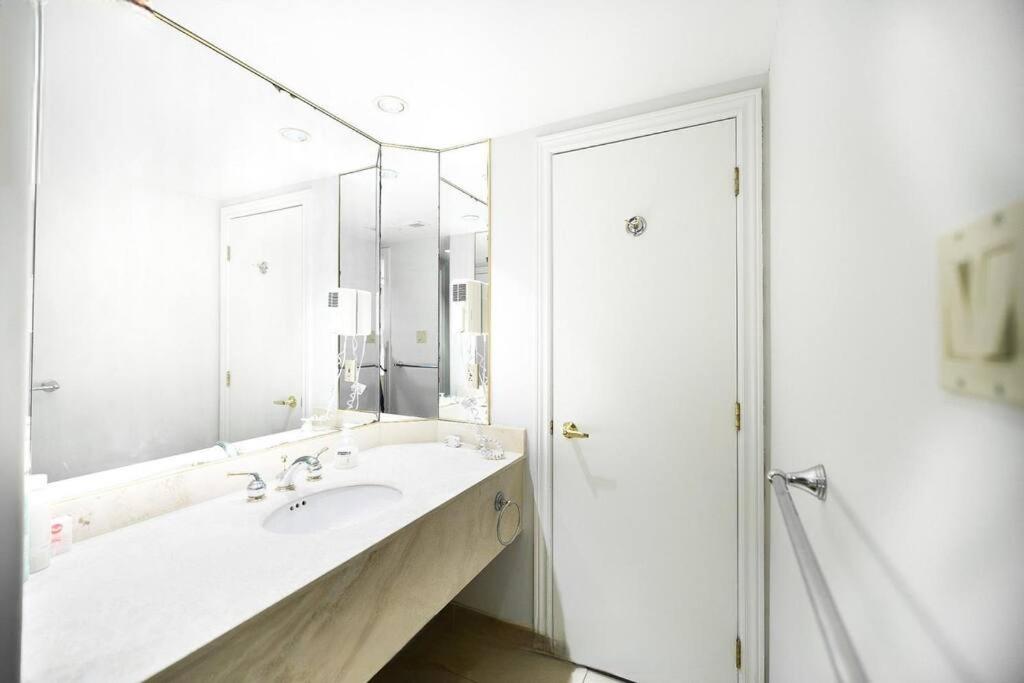 Relax & Rejuvenate at 2BR Retreat with Pool & Gym