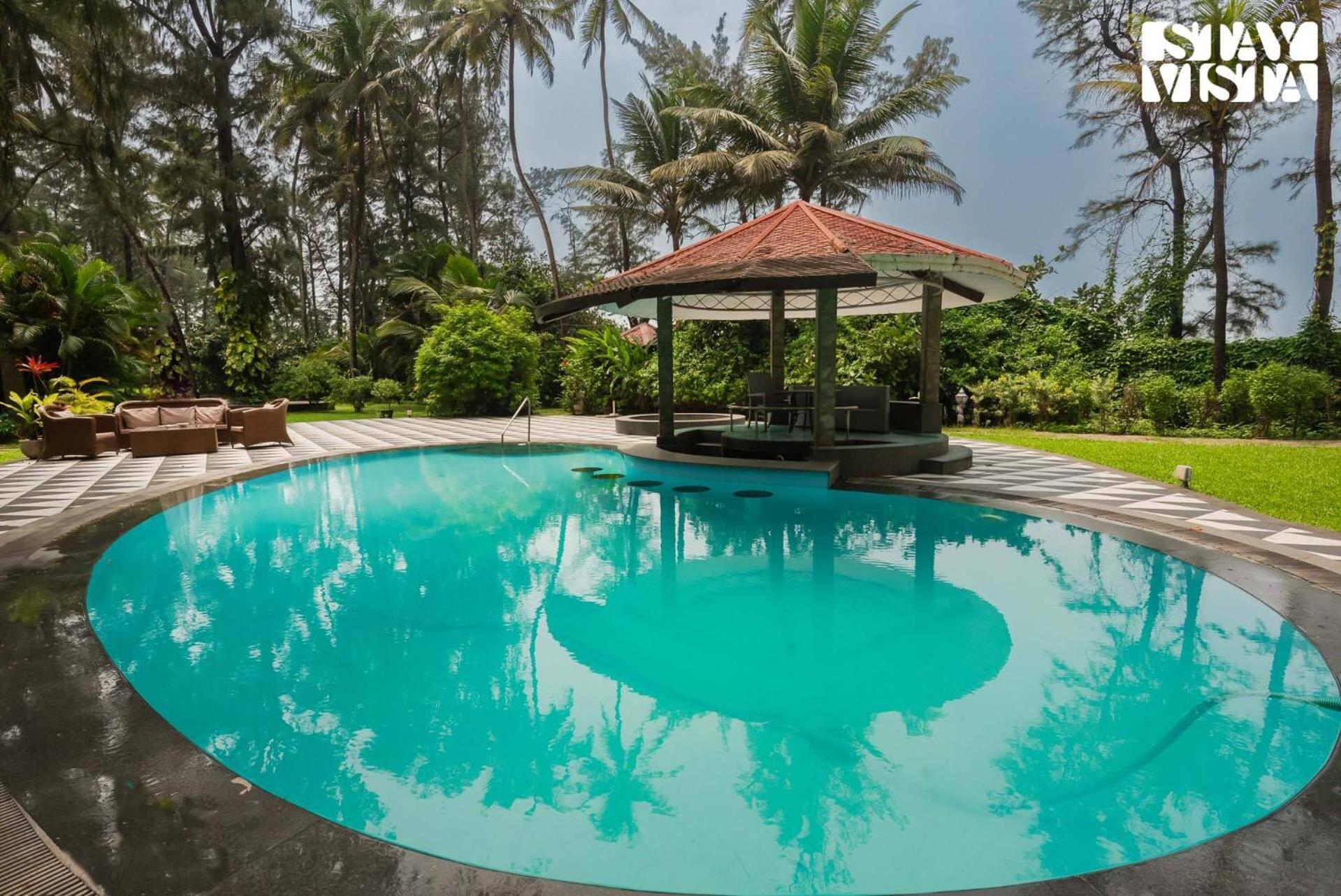 Sea Breeze by StayVista - Beachside bliss with a splash of creativity with Pool, gazebo, lush lawn, and an artistically inspired house view 2