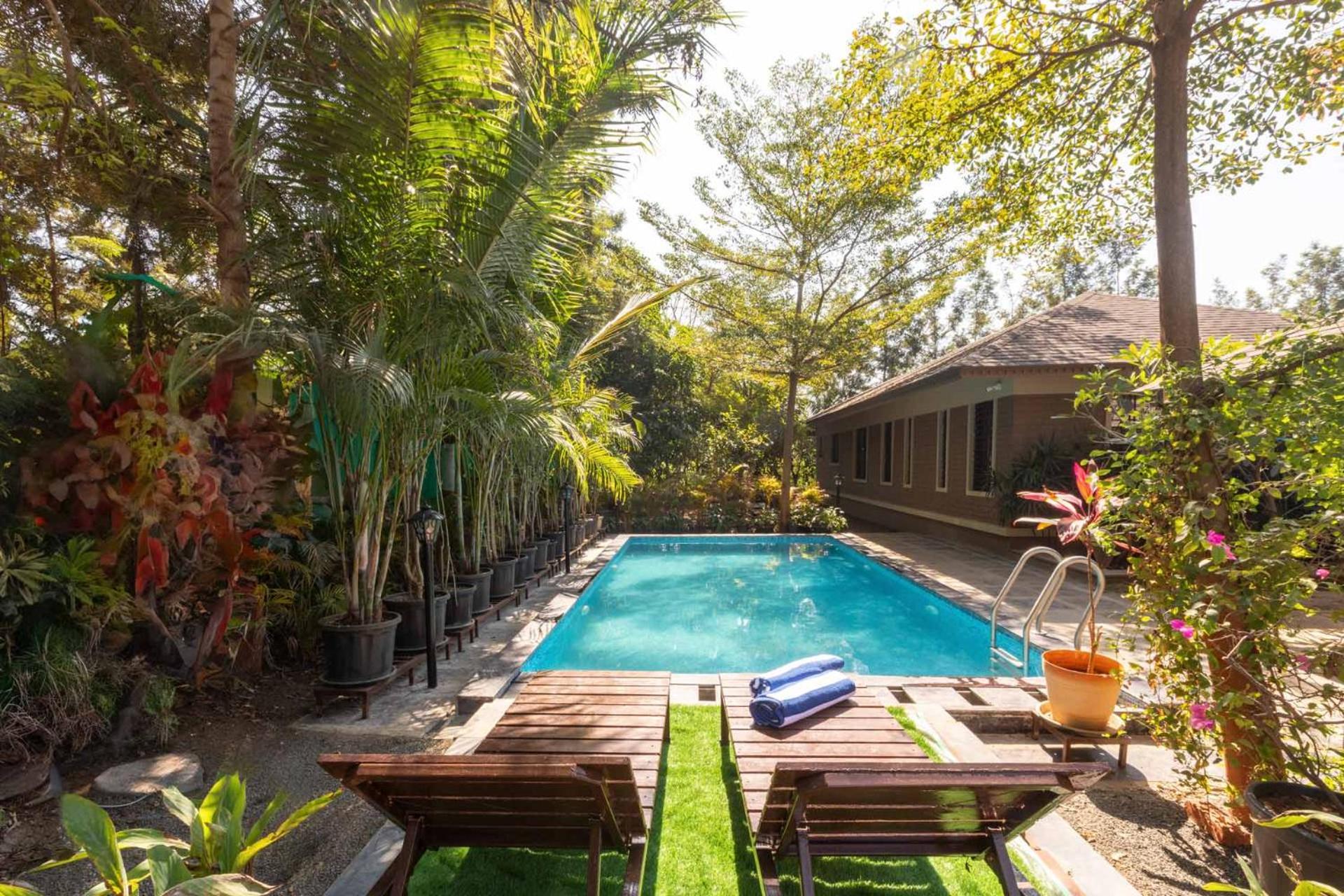 Farmhouse Retreat by StayVista - Classic architecture, Rustic interiors, Cozy rooms & A refreshing swimming pool view 3
