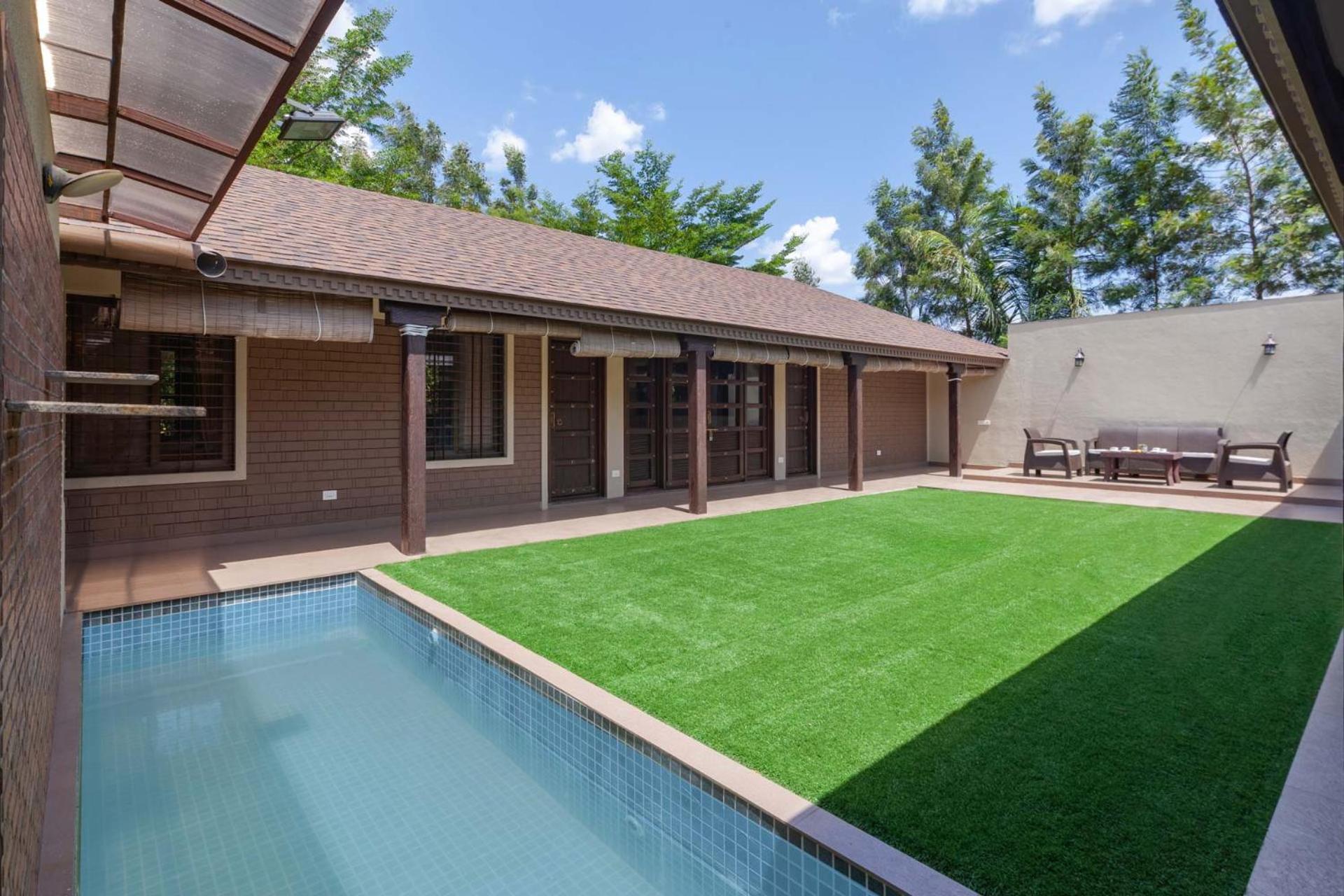 Farmhouse Retreat by StayVista - Classic architecture, Rustic interiors, Cozy rooms & A refreshing swimming pool view 4