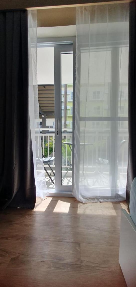 Amani Grand Resort Residences by JC SpaceRentals balcony pool view, Ground floor, 5mins from airport, free WIFI, NETFLIX view 2