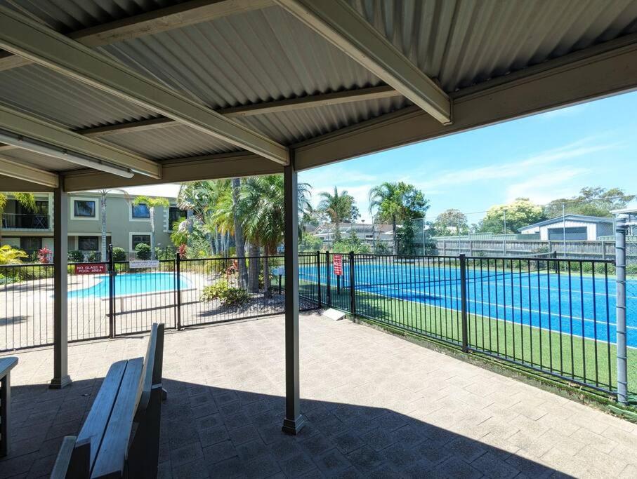 Leafy seaside unit with lagoon style pool and tennis court