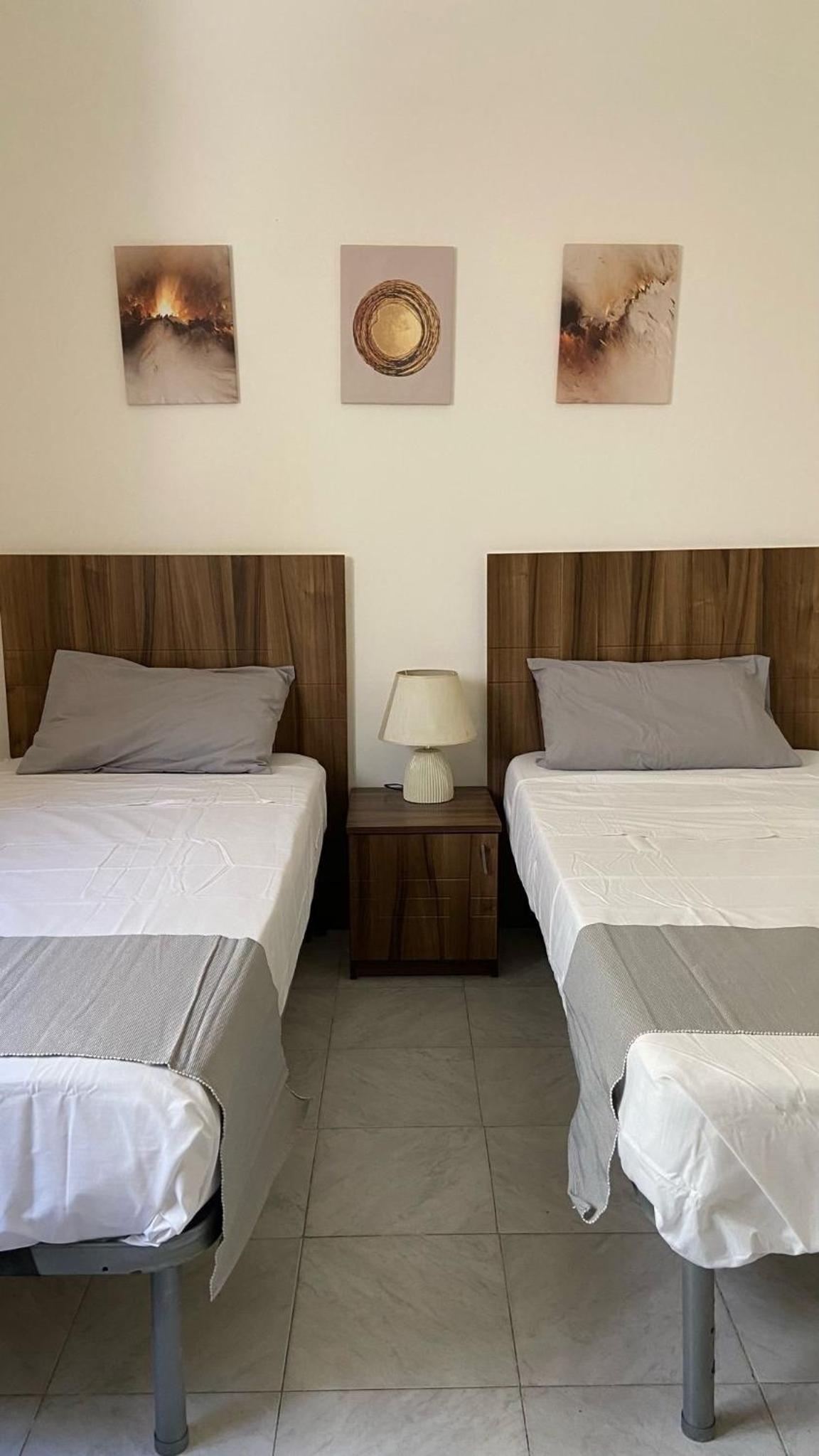 Spacious room with 2 single beds shared bathroom, st Julians view 2