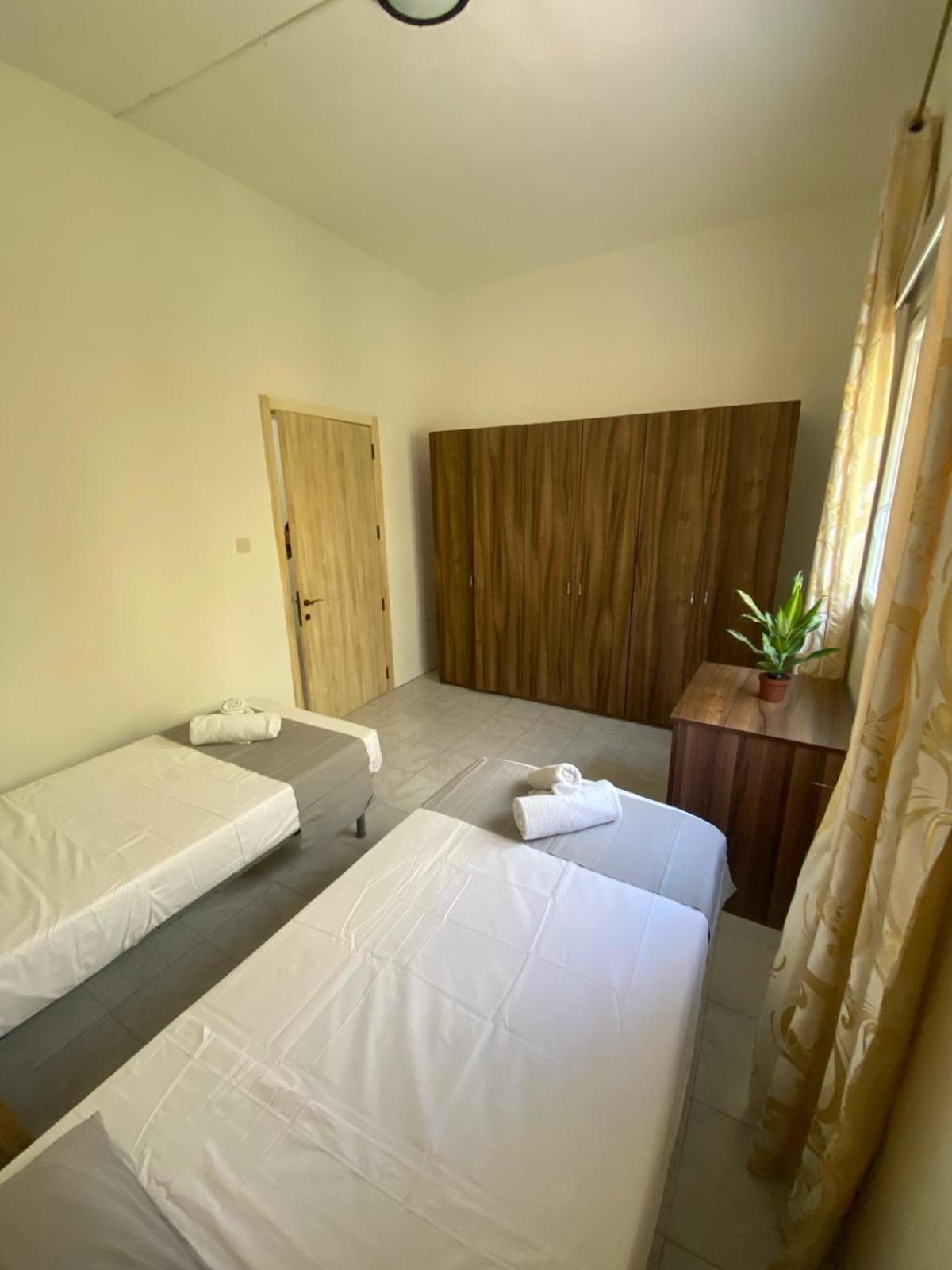 Spacious room with 2 single beds shared bathroom, st Julians view 3