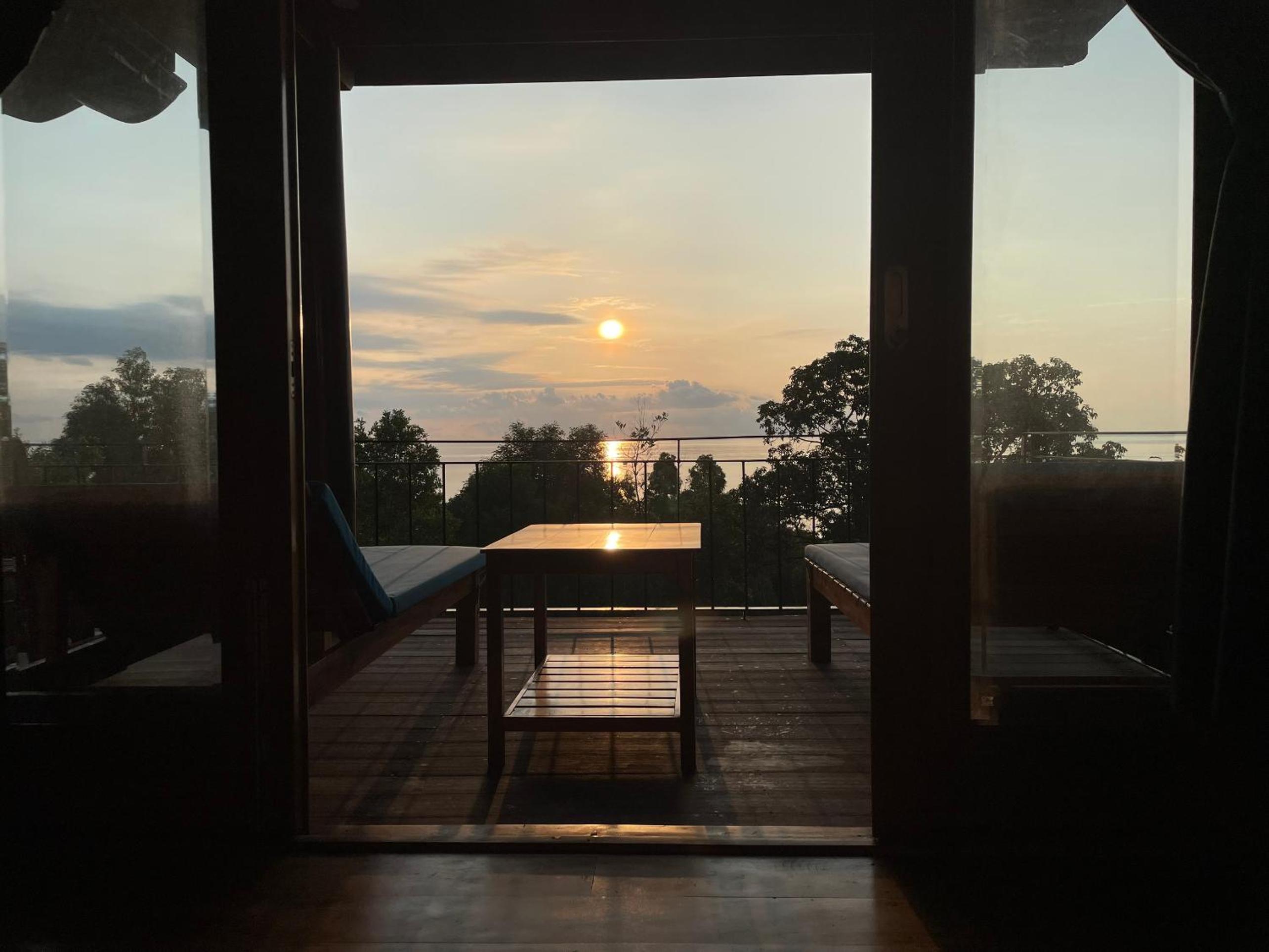 Amazing sunrise over wooden house at the East