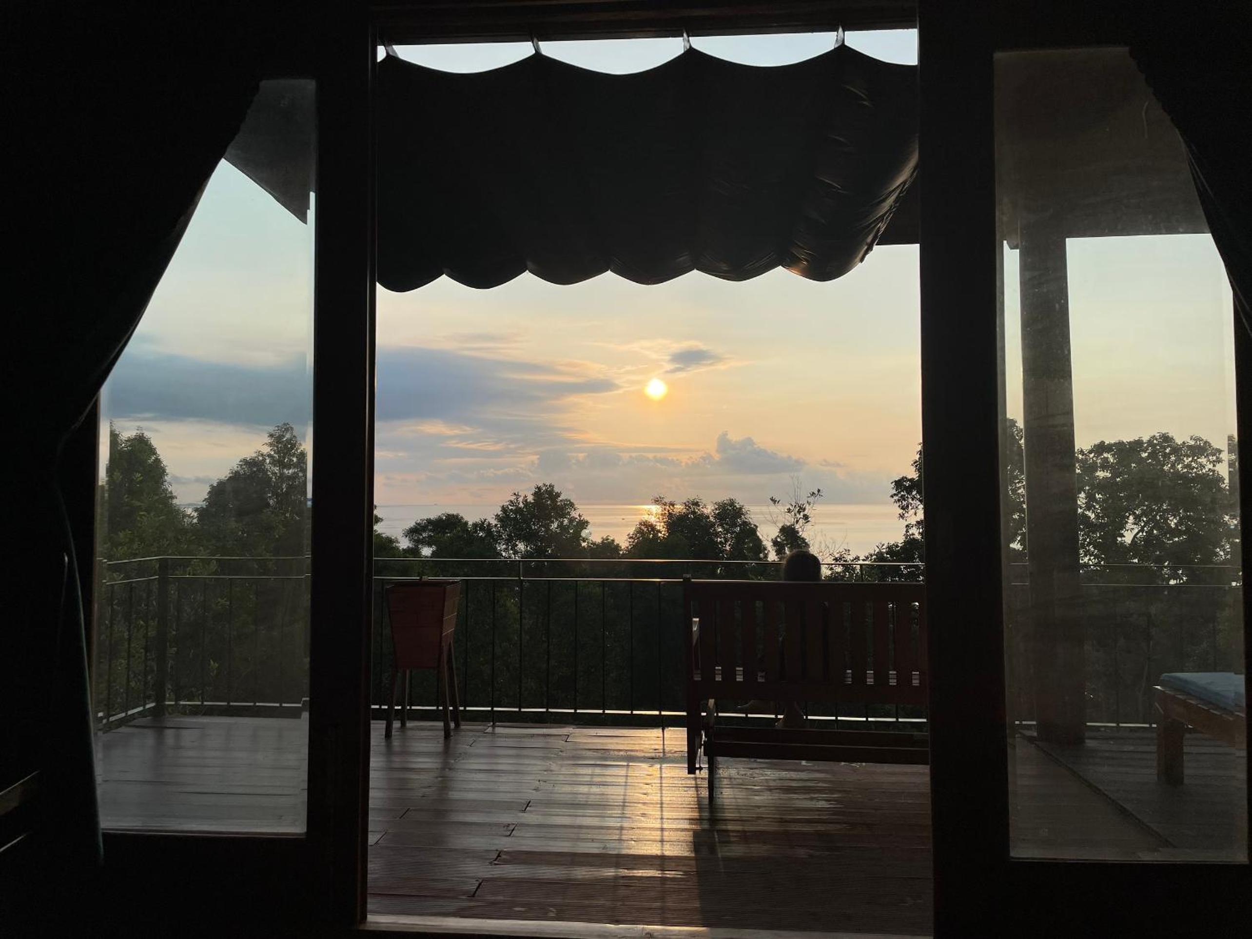 Amazing sunrise over wooden house at the East