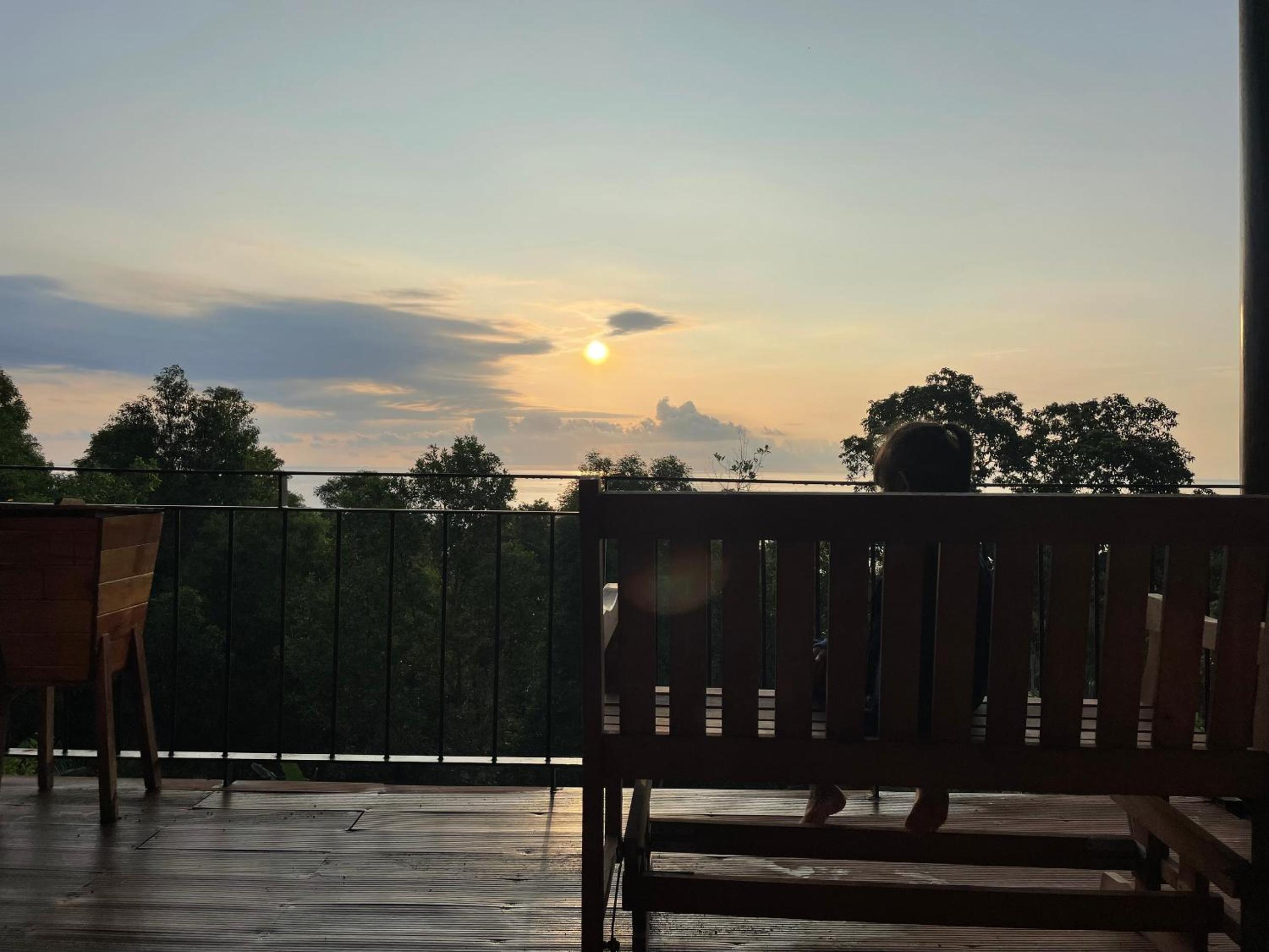Amazing sunrise over wooden house at the East