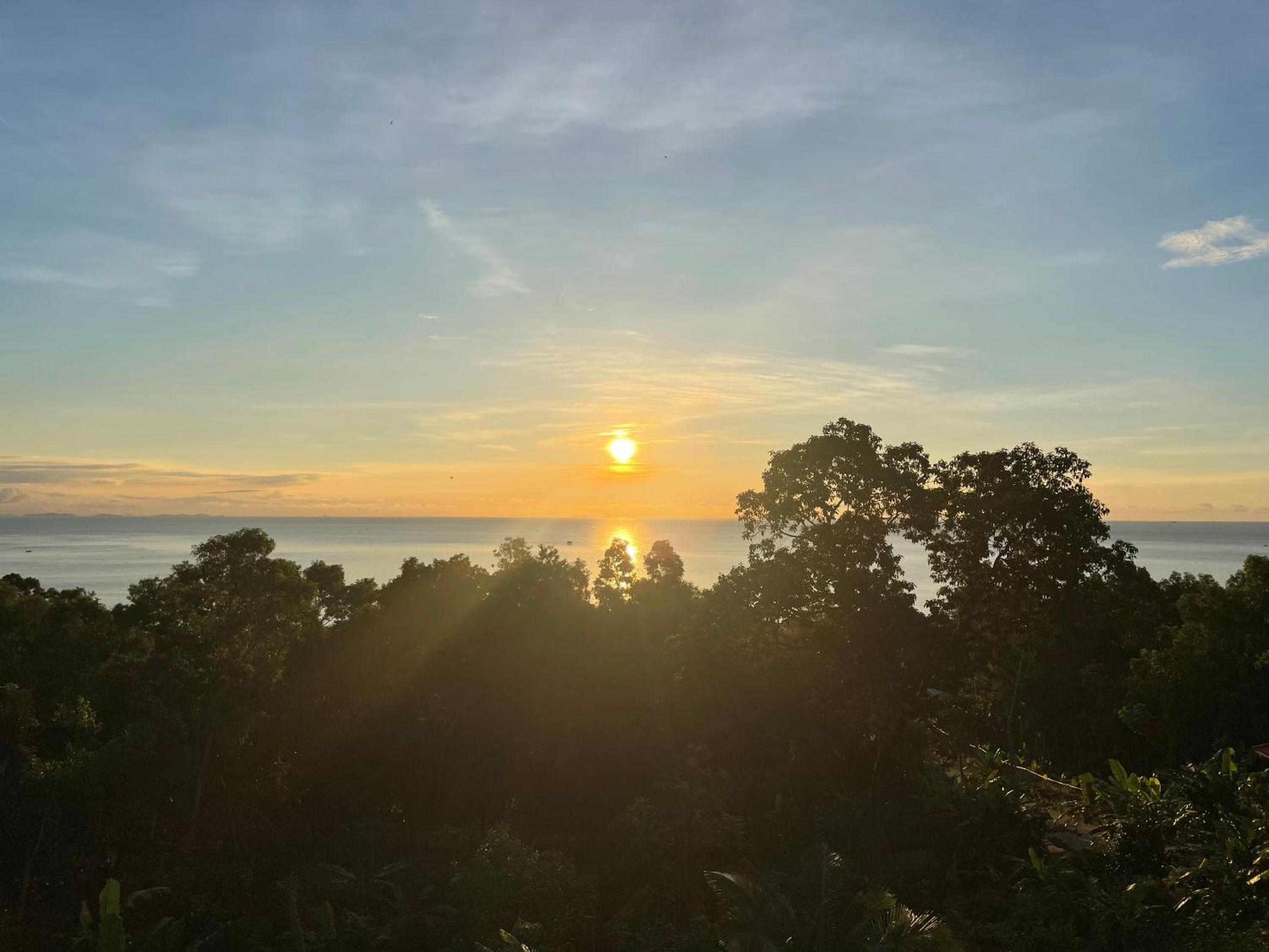 Amazing sunrise over wooden house at the East