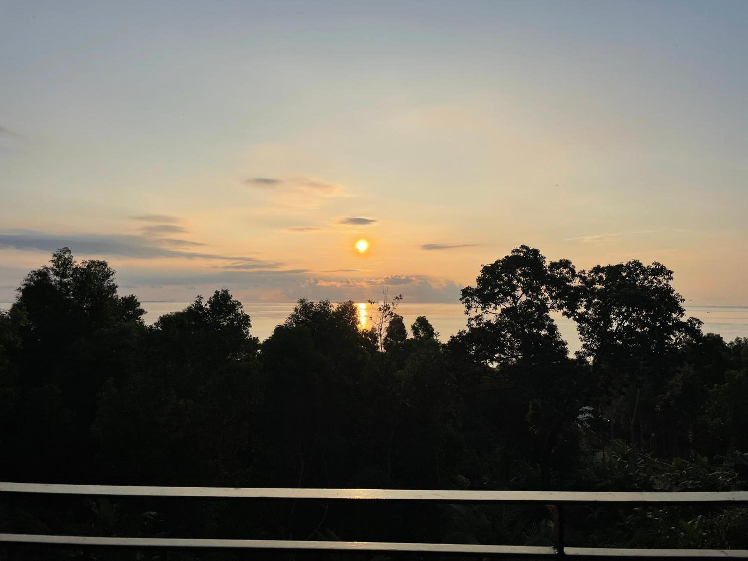 Amazing sunrise over wooden house at the East