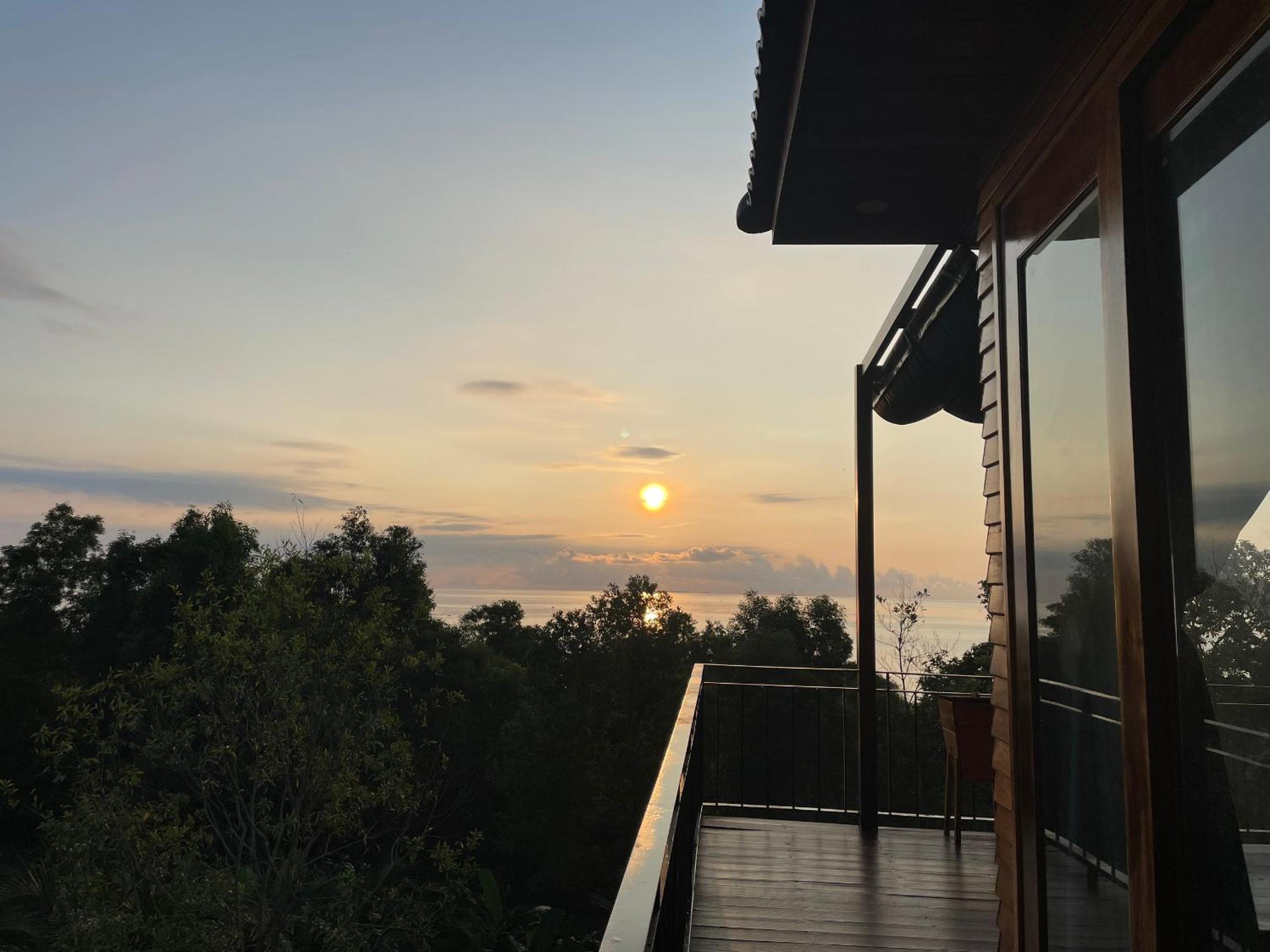 Amazing sunrise over wooden house at the East