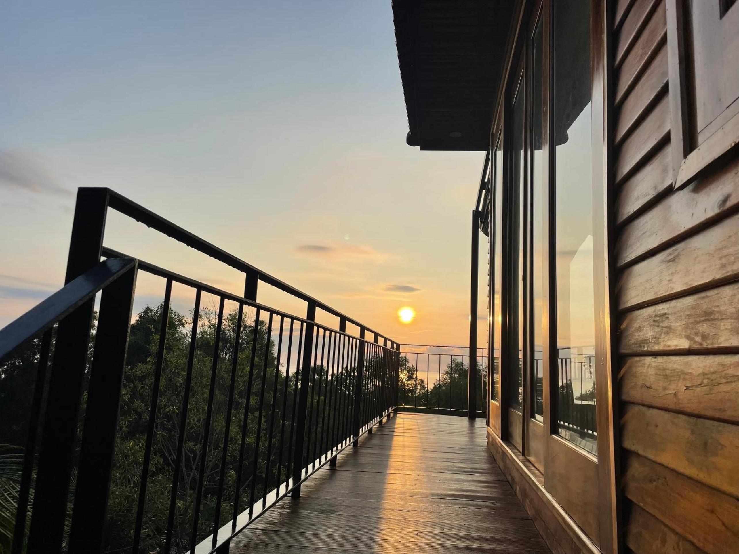 Amazing sunrise over wooden house at the East