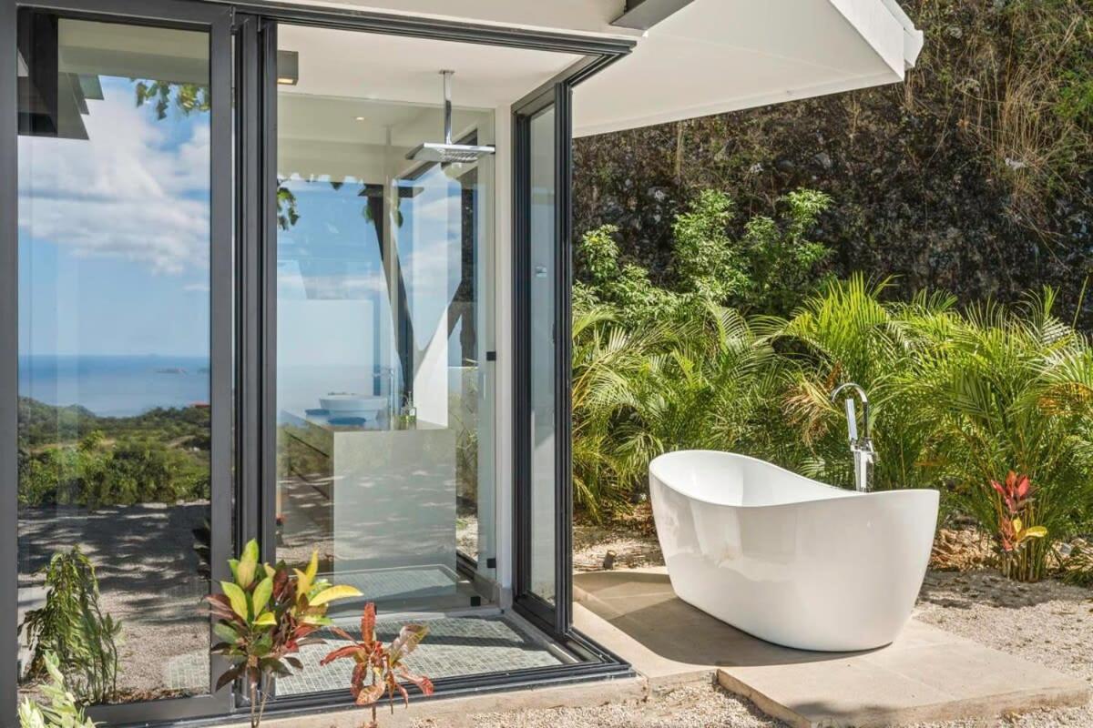 Luxurious Ultramodern Property with Private Suites, Infinity Pool, and Sweeping Ocean and Mountain Views