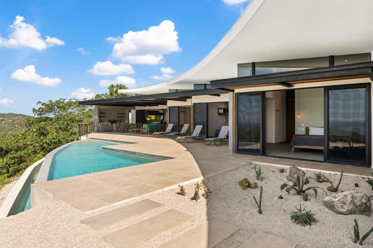 Luxurious Ultramodern Property with Private Suites, Infinity Pool, and Sweeping Ocean and Mountain Views