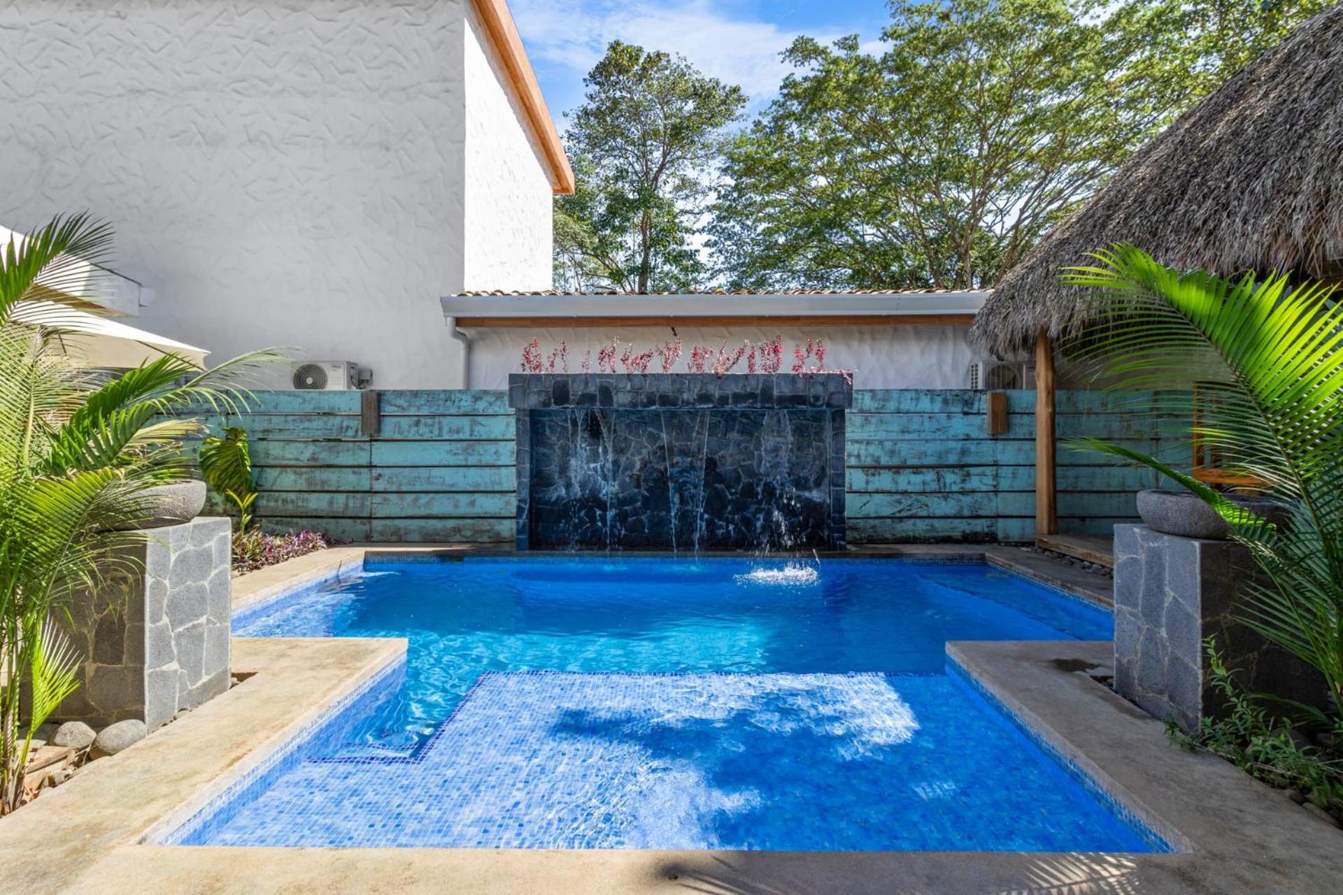 Modern Home with Chic Bohemian Style and Zen Outdoor Oasis with Swimming Pool and Tiki Style Dining Space