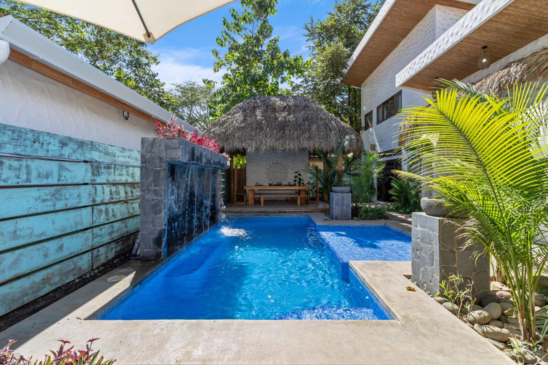 Modern Home with Chic Bohemian Style and Zen Outdoor Oasis with Swimming Pool and Tiki Style Dining Space