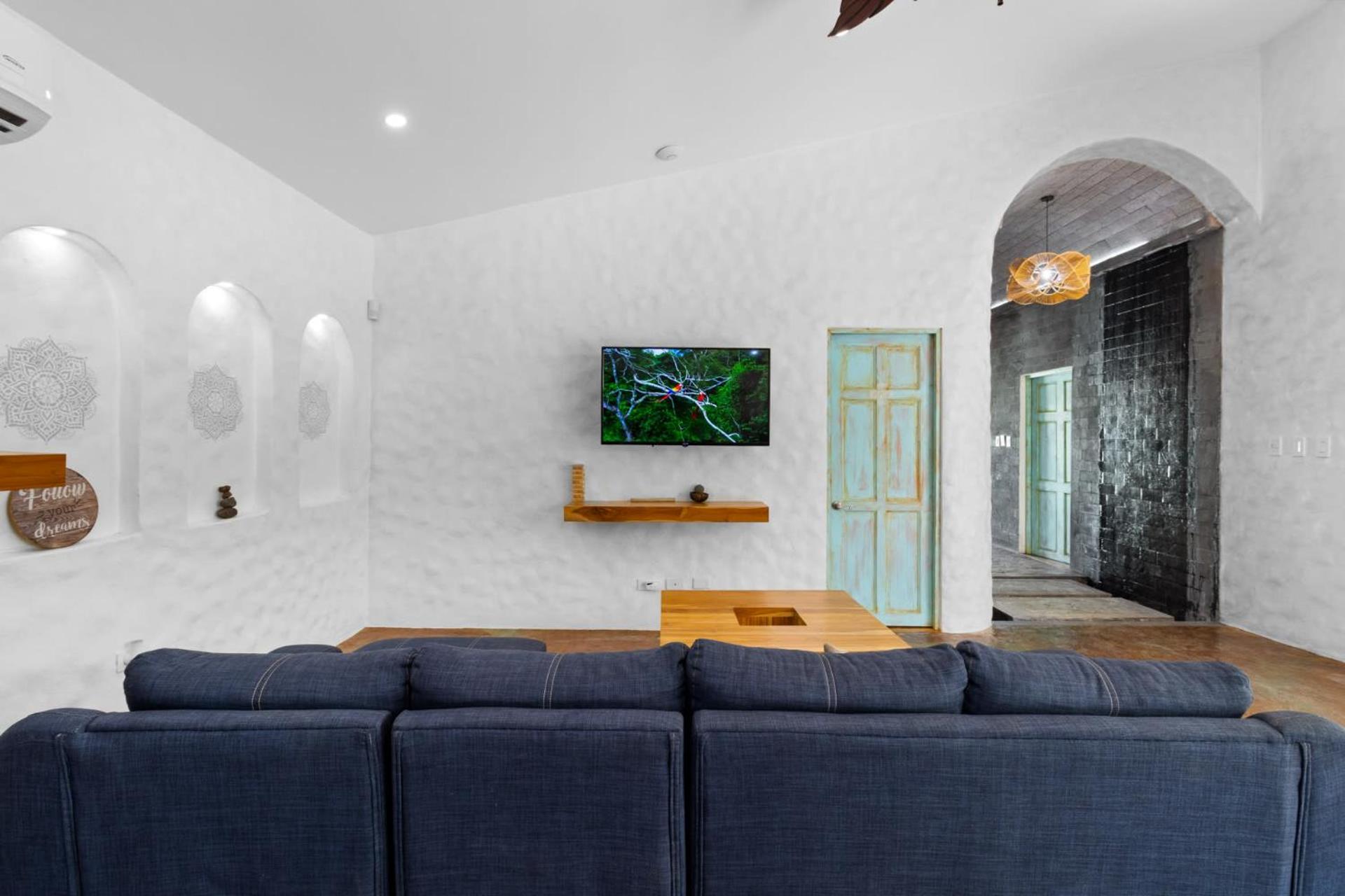 Modern Home with Chic Bohemian Style and Zen Outdoor Oasis with Swimming Pool and Tiki Style Dining Space