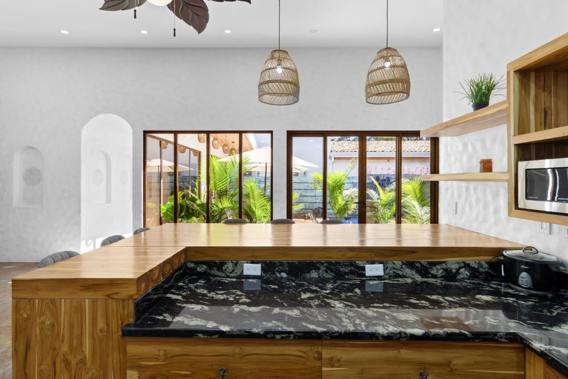 Modern Home with Chic Bohemian Style and Zen Outdoor Oasis with Swimming Pool and Tiki Style Dining Space