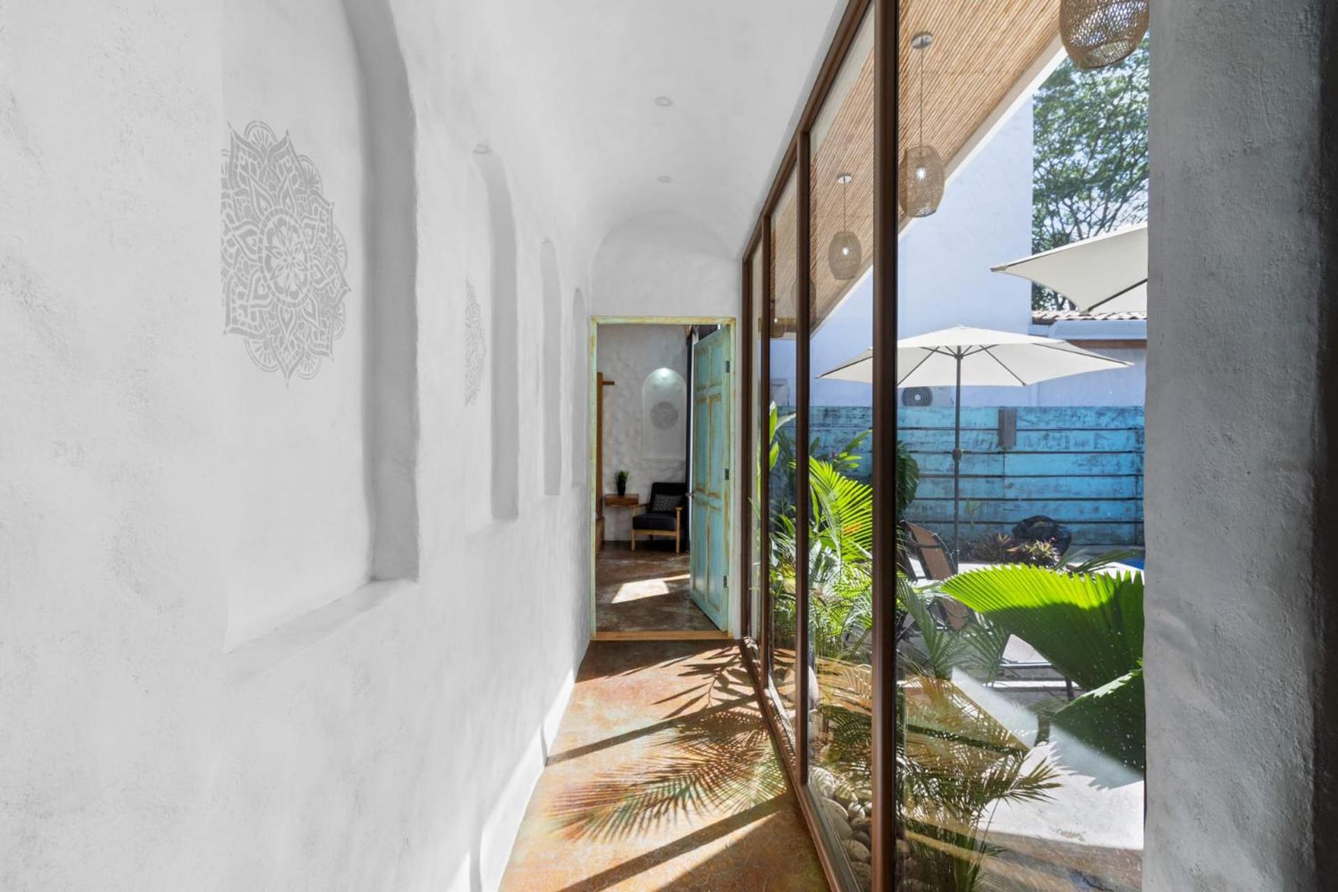 Modern Home with Chic Bohemian Style and Zen Outdoor Oasis with Swimming Pool and Tiki Style Dining Space