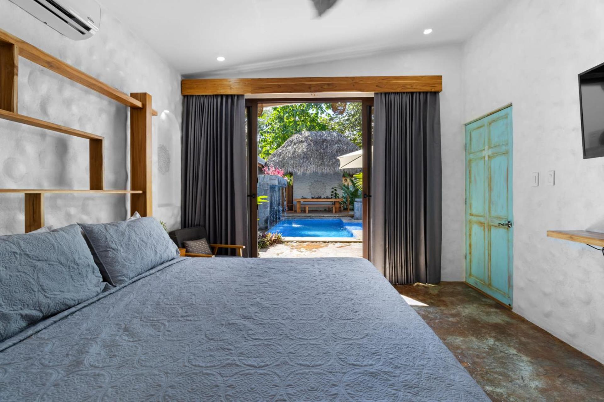 Modern Home with Chic Bohemian Style and Zen Outdoor Oasis with Swimming Pool and Tiki Style Dining Space