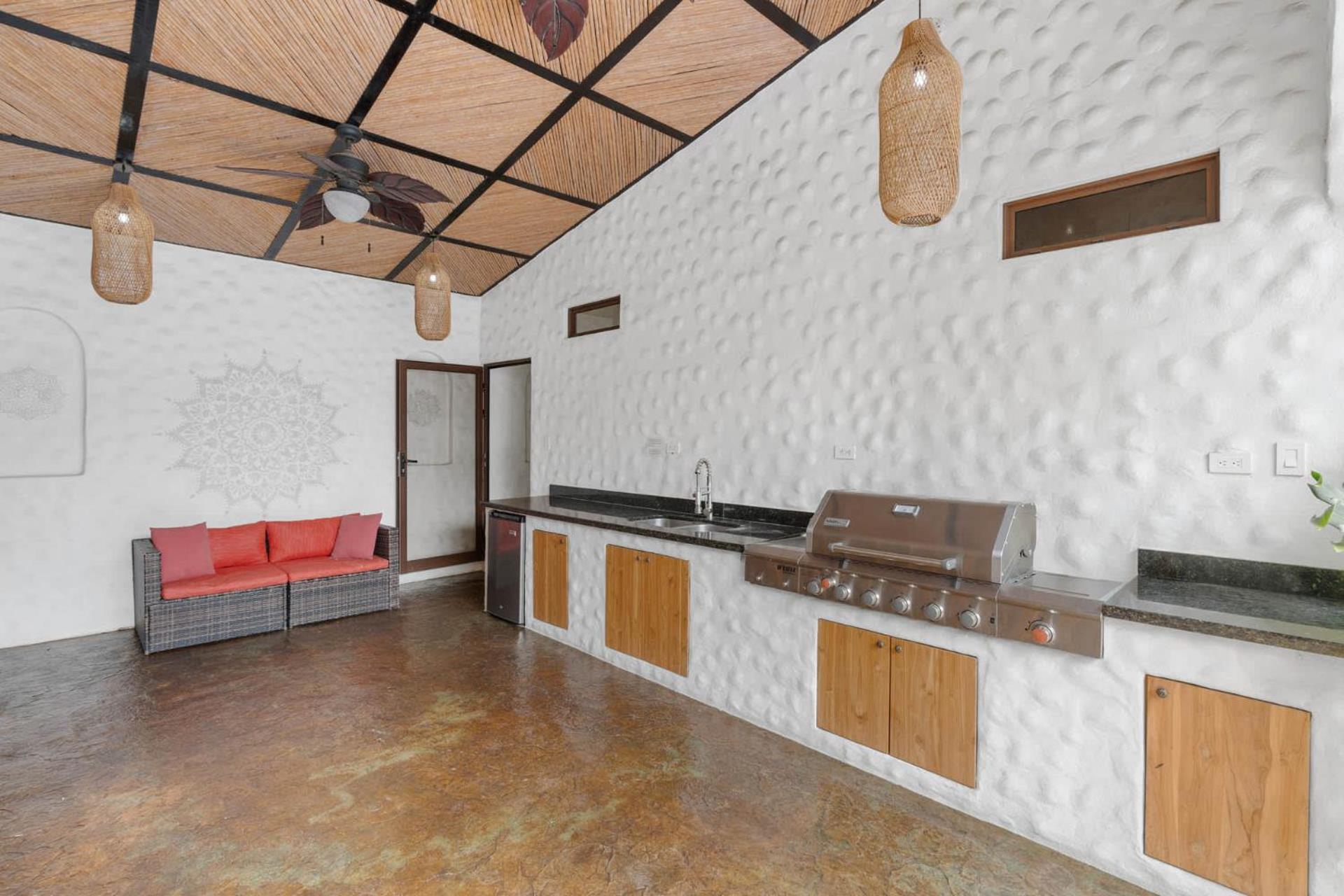 Modern Home with Chic Bohemian Style and Zen Outdoor Oasis with Swimming Pool and Tiki Style Dining Space