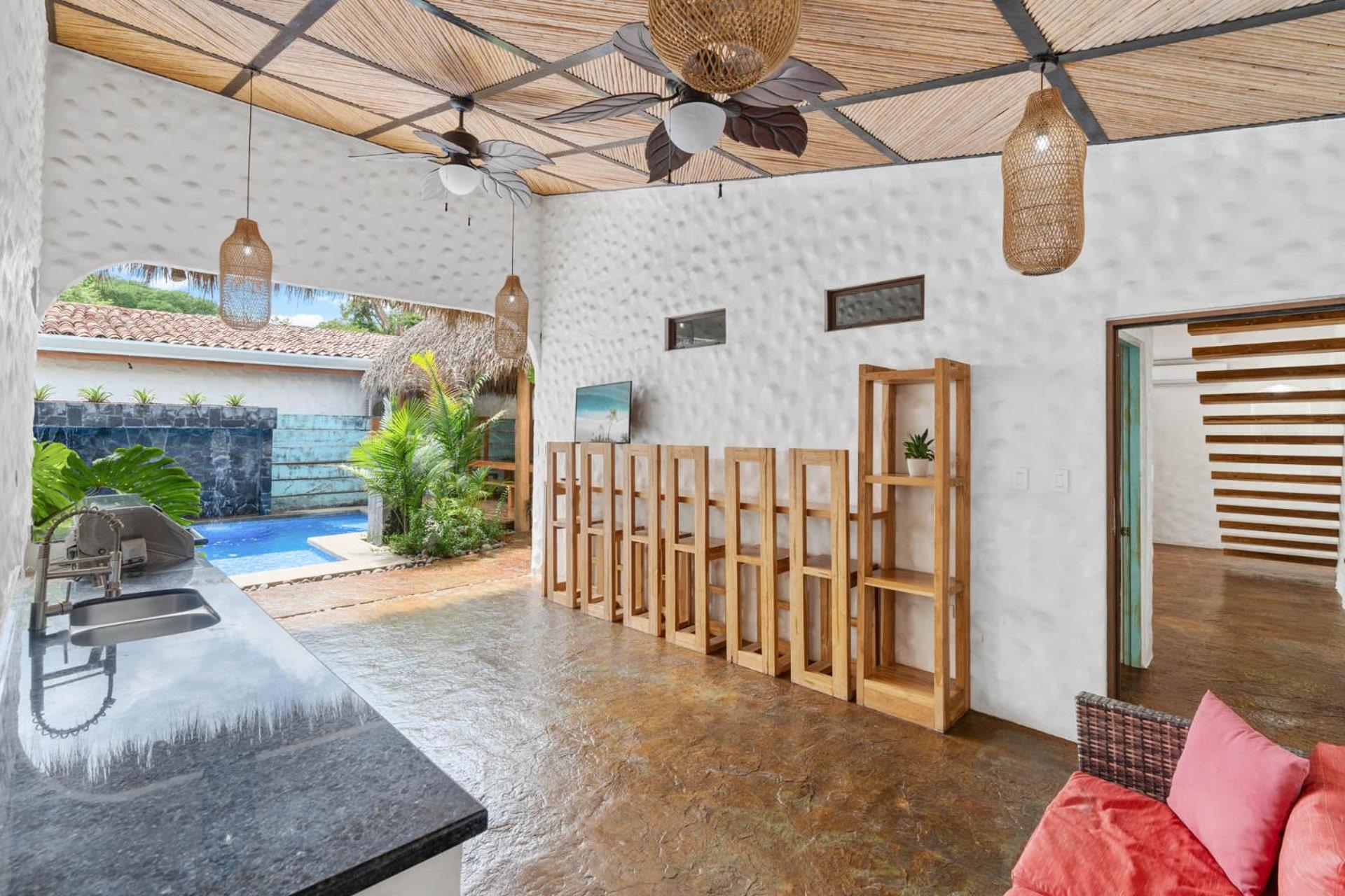 Modern Home with Chic Bohemian Style and Zen Outdoor Oasis with Swimming Pool and Tiki Style Dining Space