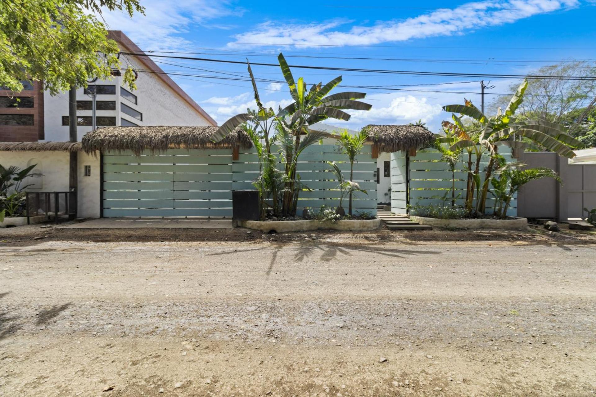 Modern Home with Chic Bohemian Style and Zen Outdoor Oasis with Swimming Pool and Tiki Style Dining Space