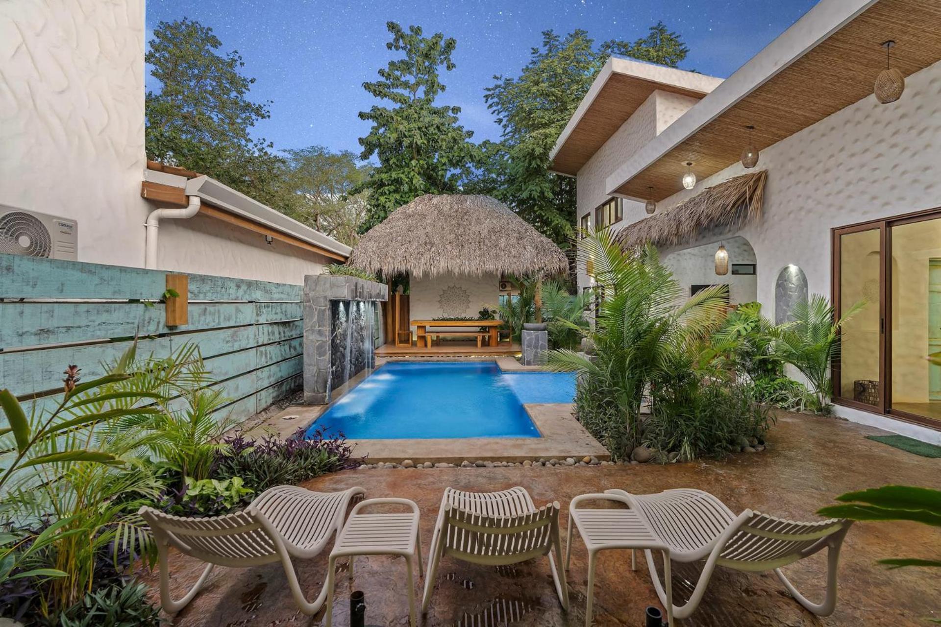 Modern Home with Chic Bohemian Style and Zen Outdoor Oasis with Swimming Pool and Tiki Style Dining Space