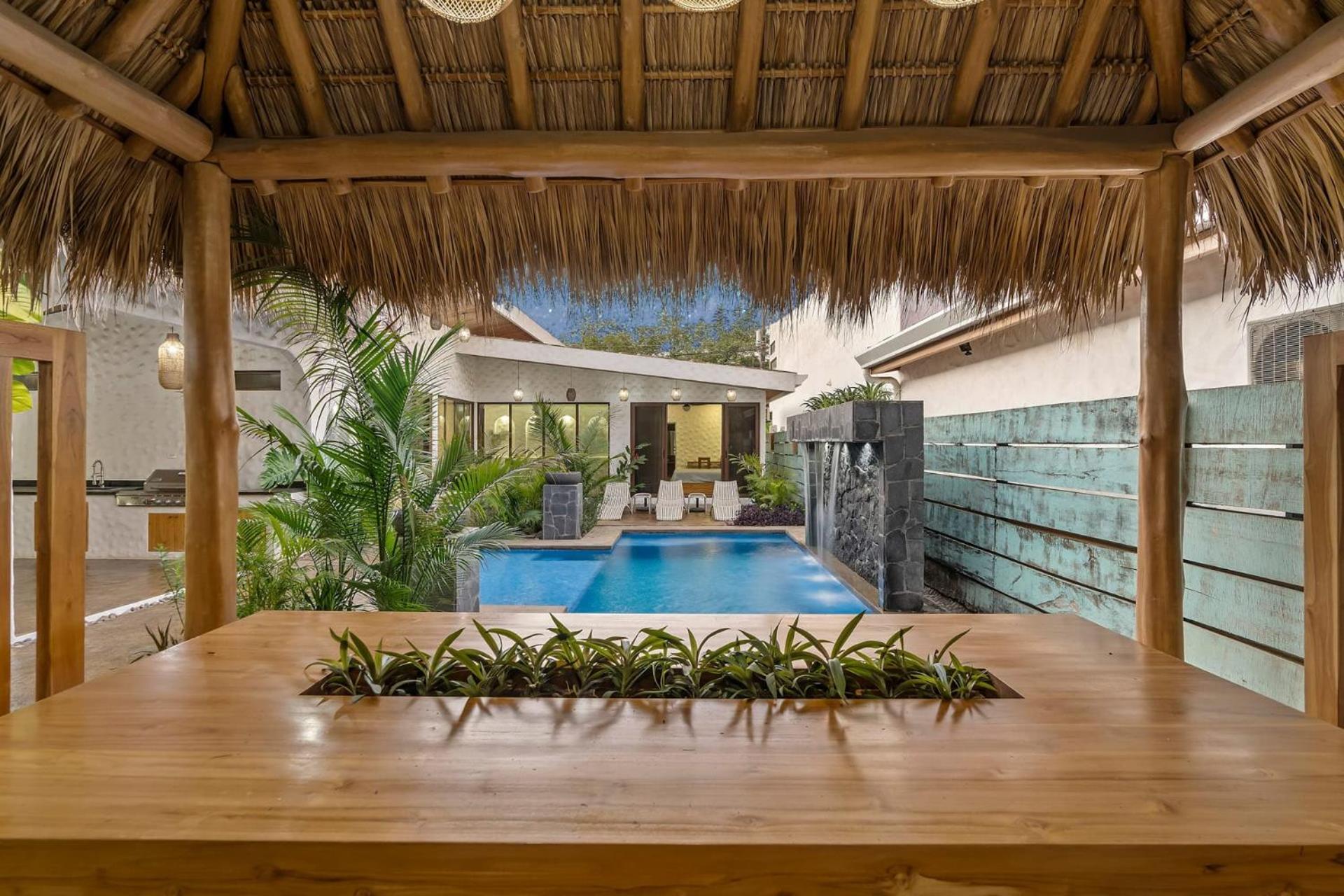 Modern Home with Chic Bohemian Style and Zen Outdoor Oasis with Swimming Pool and Tiki Style Dining Space